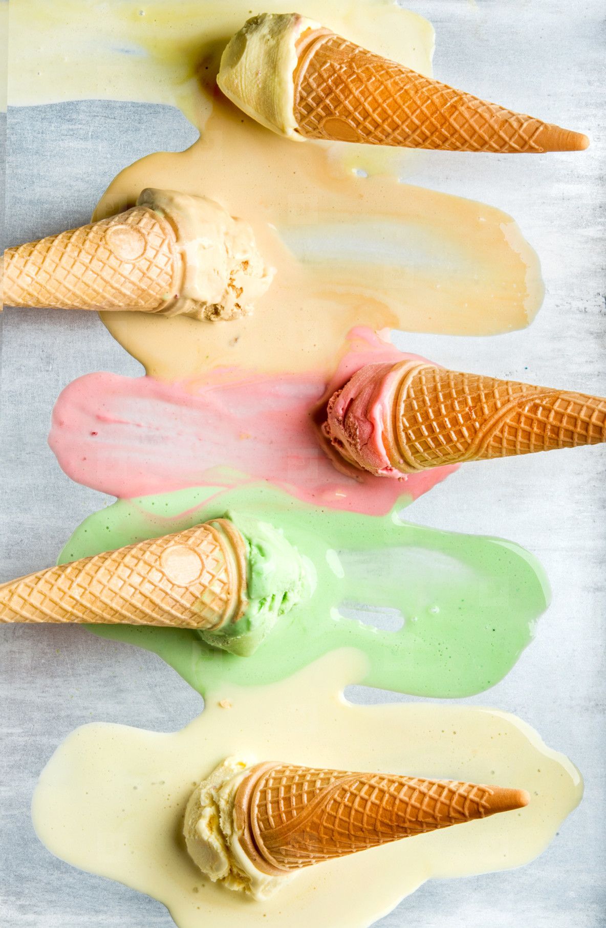 1184x1813 Colorful Ice Cream Cones Of Different Flavors. Melting Scoops. Top View, Steel Metal Background Photo