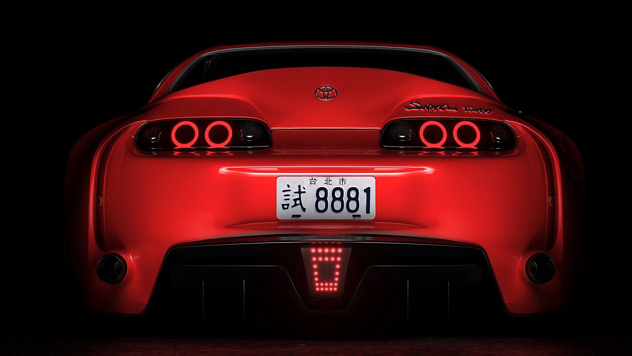 2560x1440 Download wallpaper 2560x1440 toyota supra, toyota, sportscar, red, rear view, dark, backlight widescreen 16:9 HD background