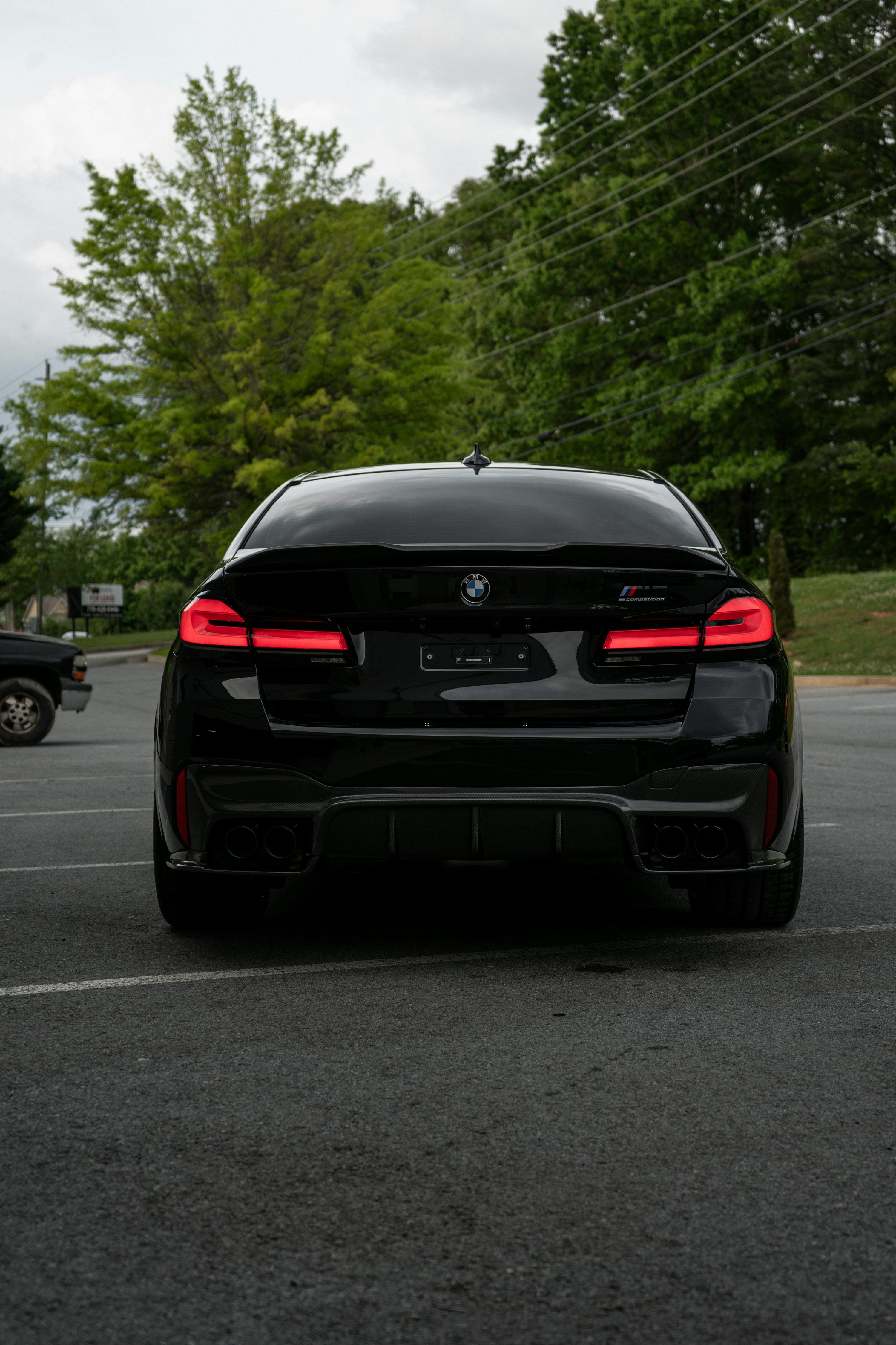 3000x4500 A black bmw car parked in a parking lot photo