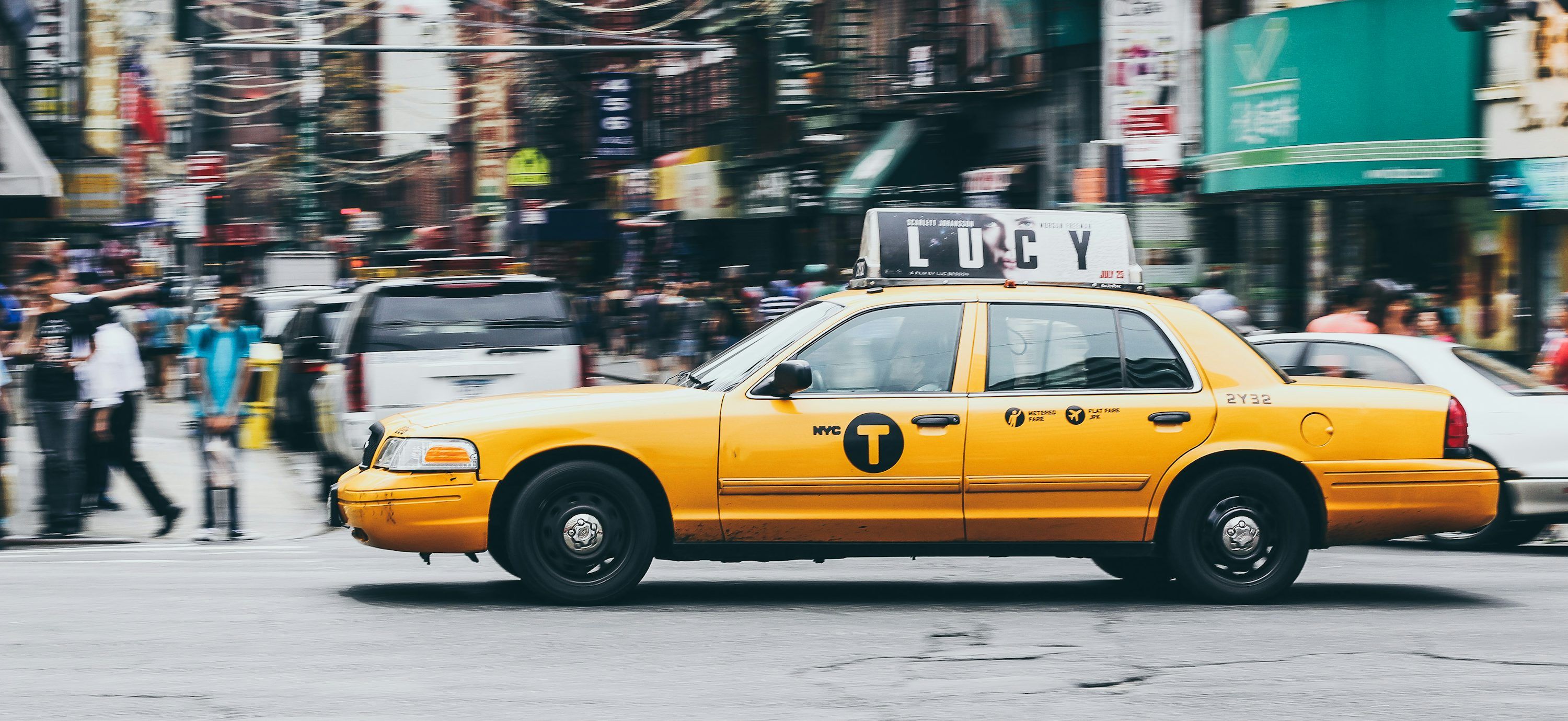 3000x1380 Yellow taxi on concrete road photo