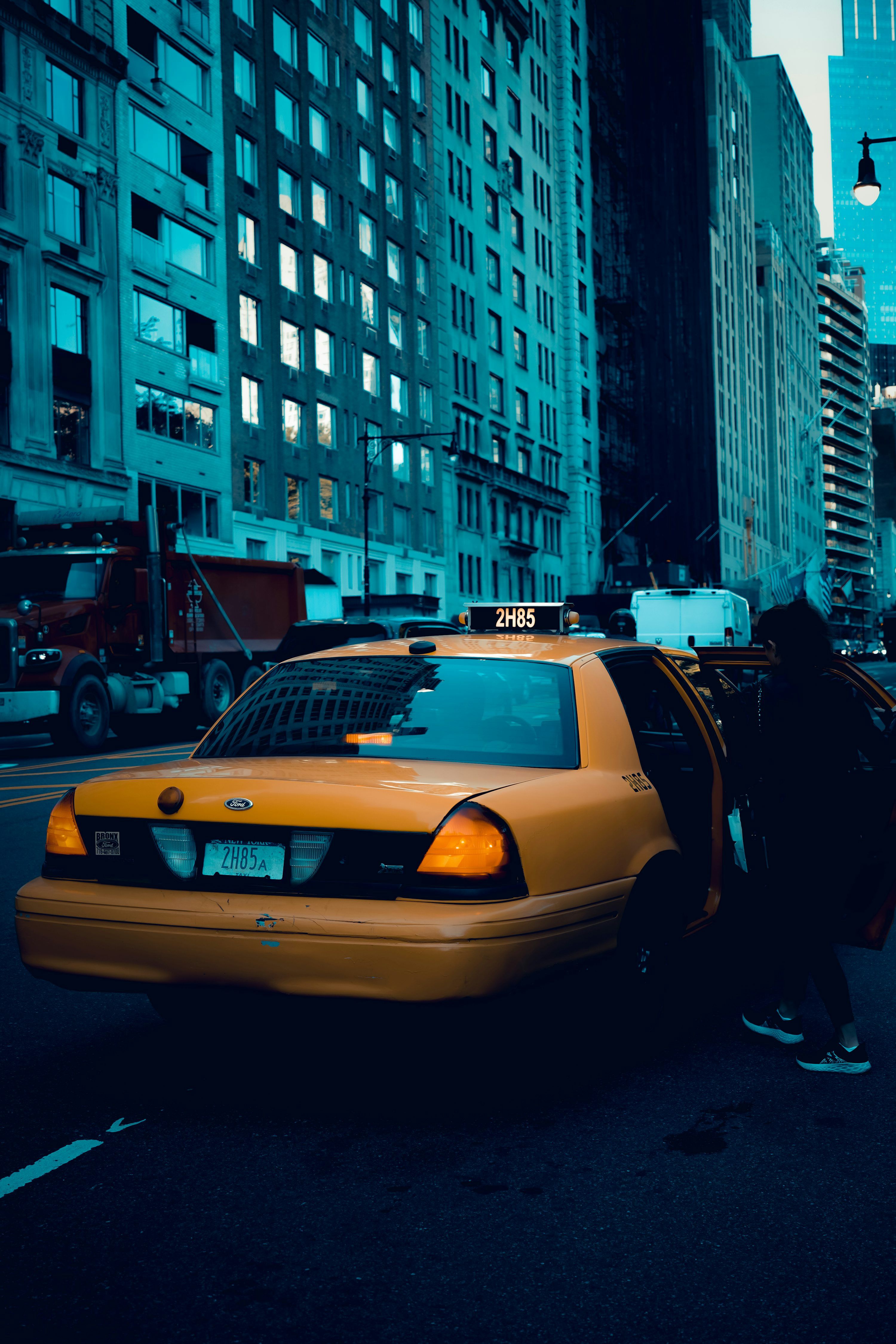 3000x4500 A taxi cab with its door open on a city street photo