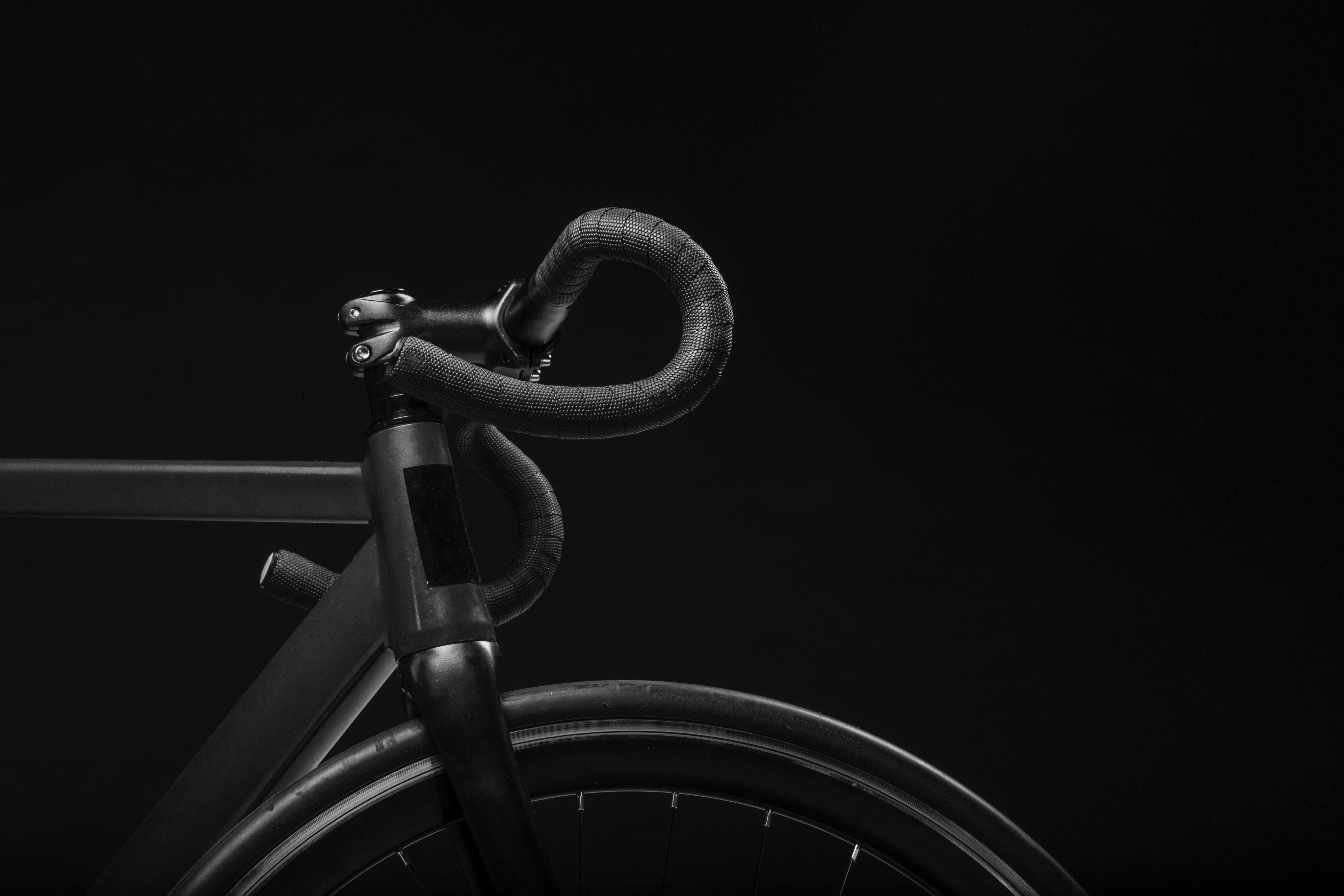 5472x3648 black road bicycle handle with black background photo