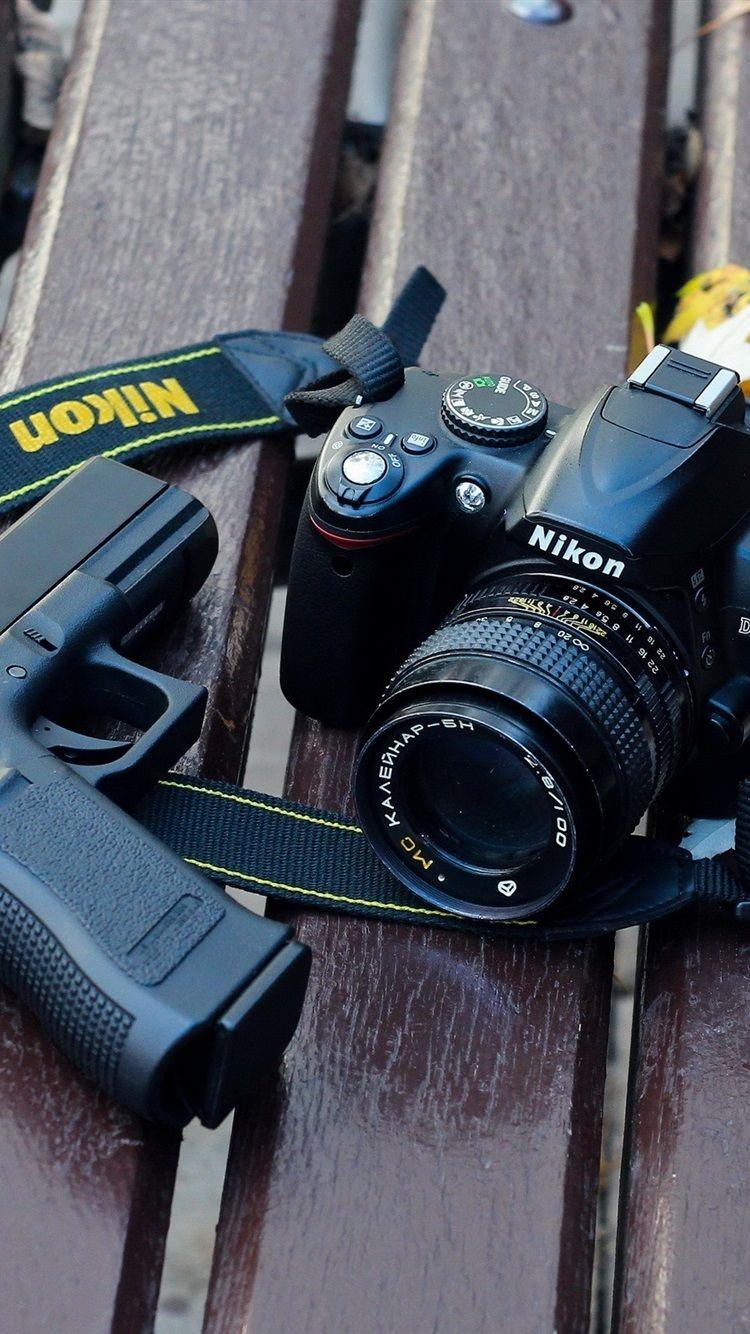 750x1334 Nikon D3000 Digital Camera And Gun 750x1334 IPhone 8 7 6 6S Wallpaper, Background, Picture, Image