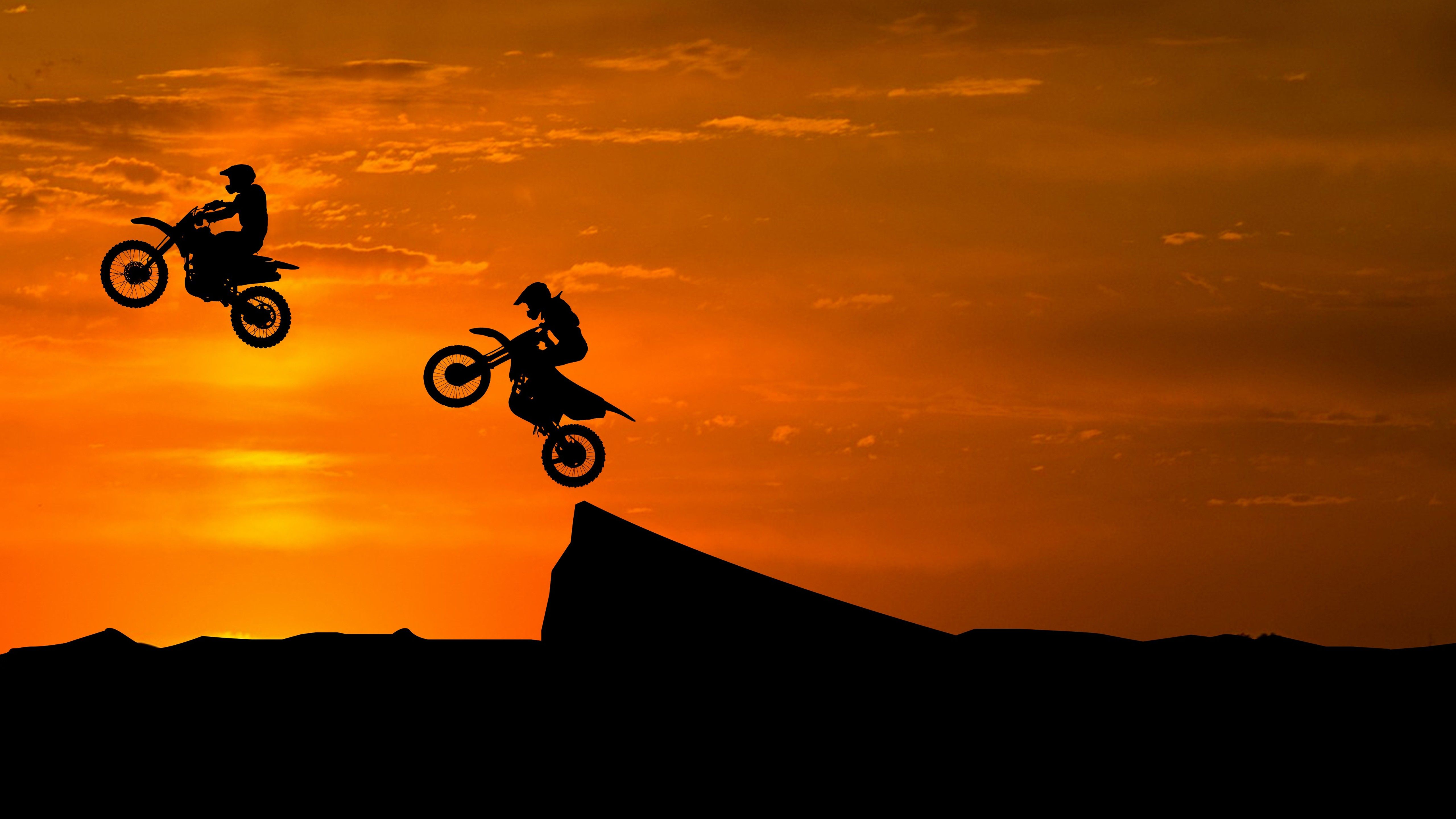 5120x2880 Stunt Bike Race Sunset Silhouette 5K Wallpaper