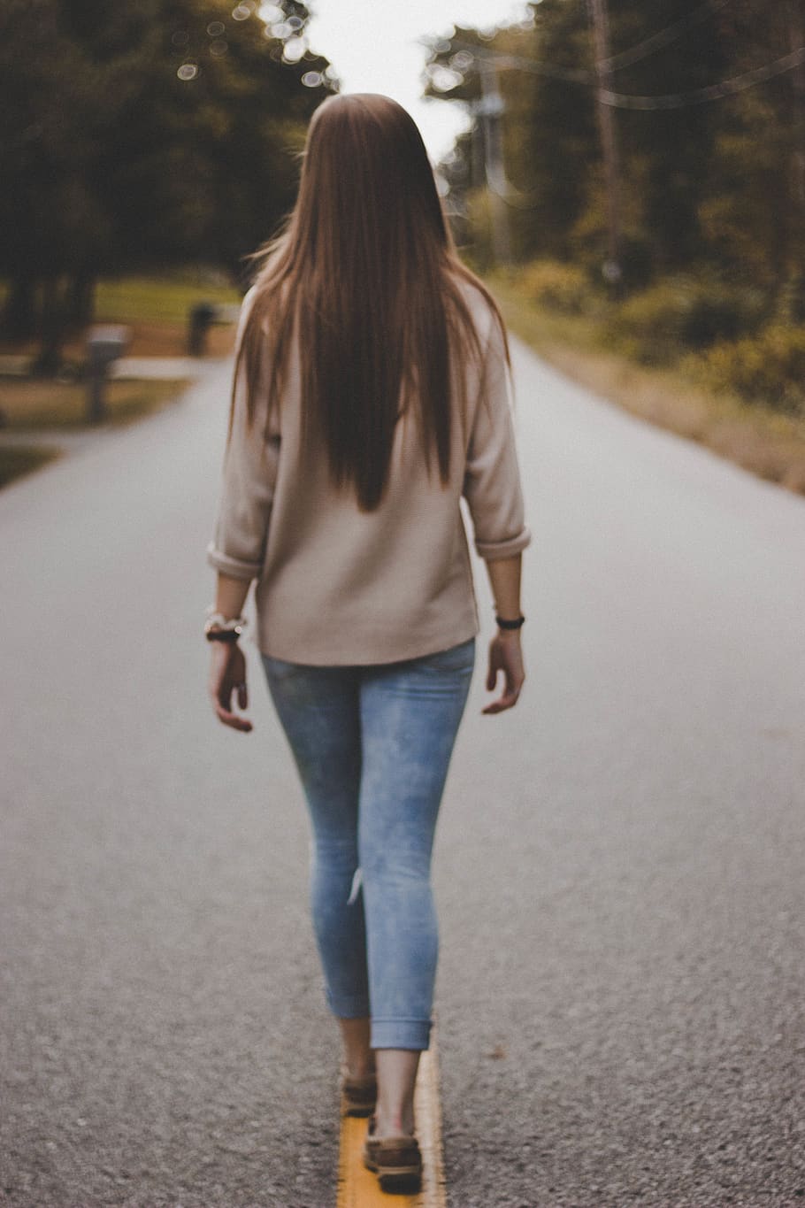 910x1365 HD wallpaper: woman in grey shirt and blue denim pants walking on road during daytime