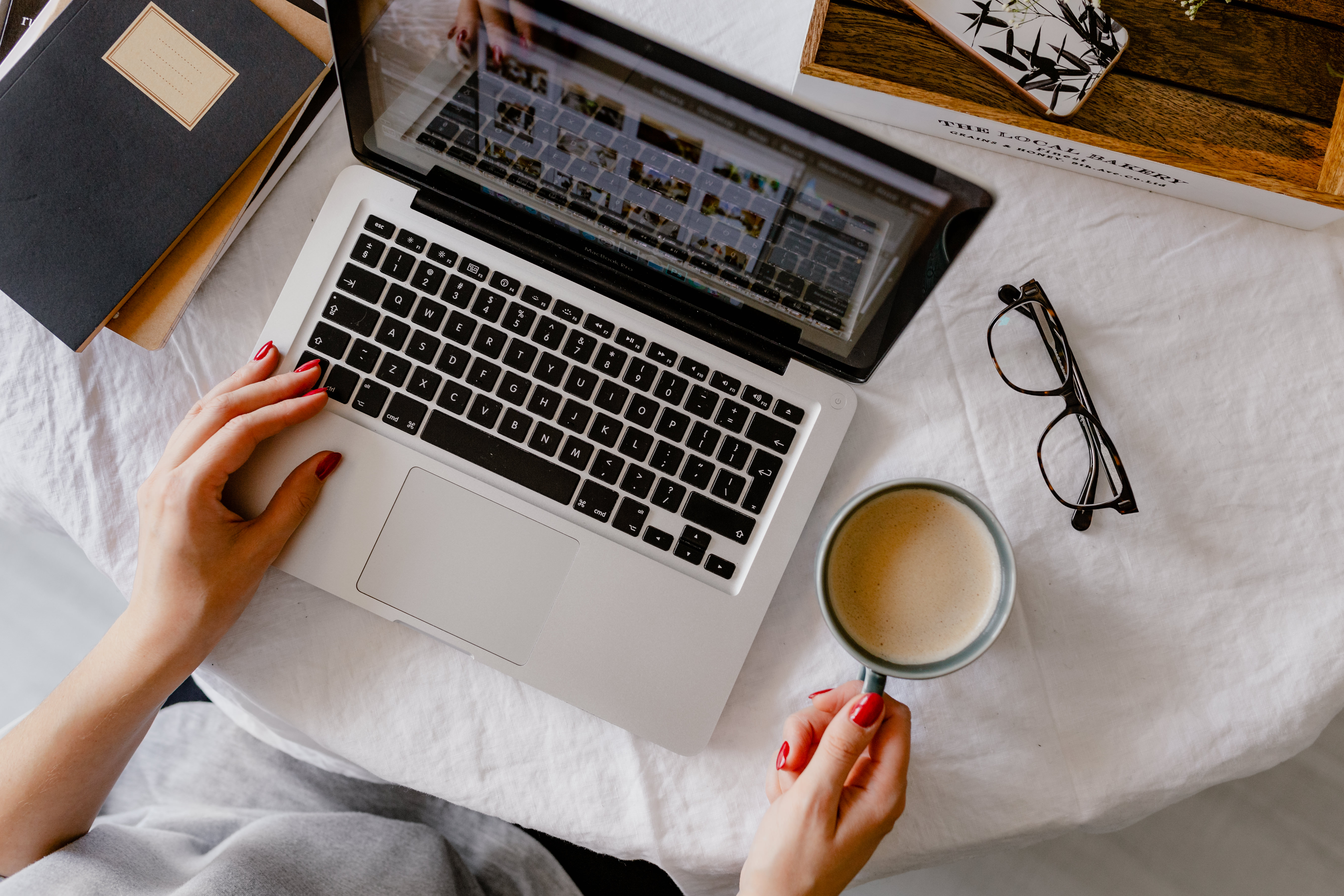 5418x3612 A woman works at a desk with a laptop and a cup of coffee