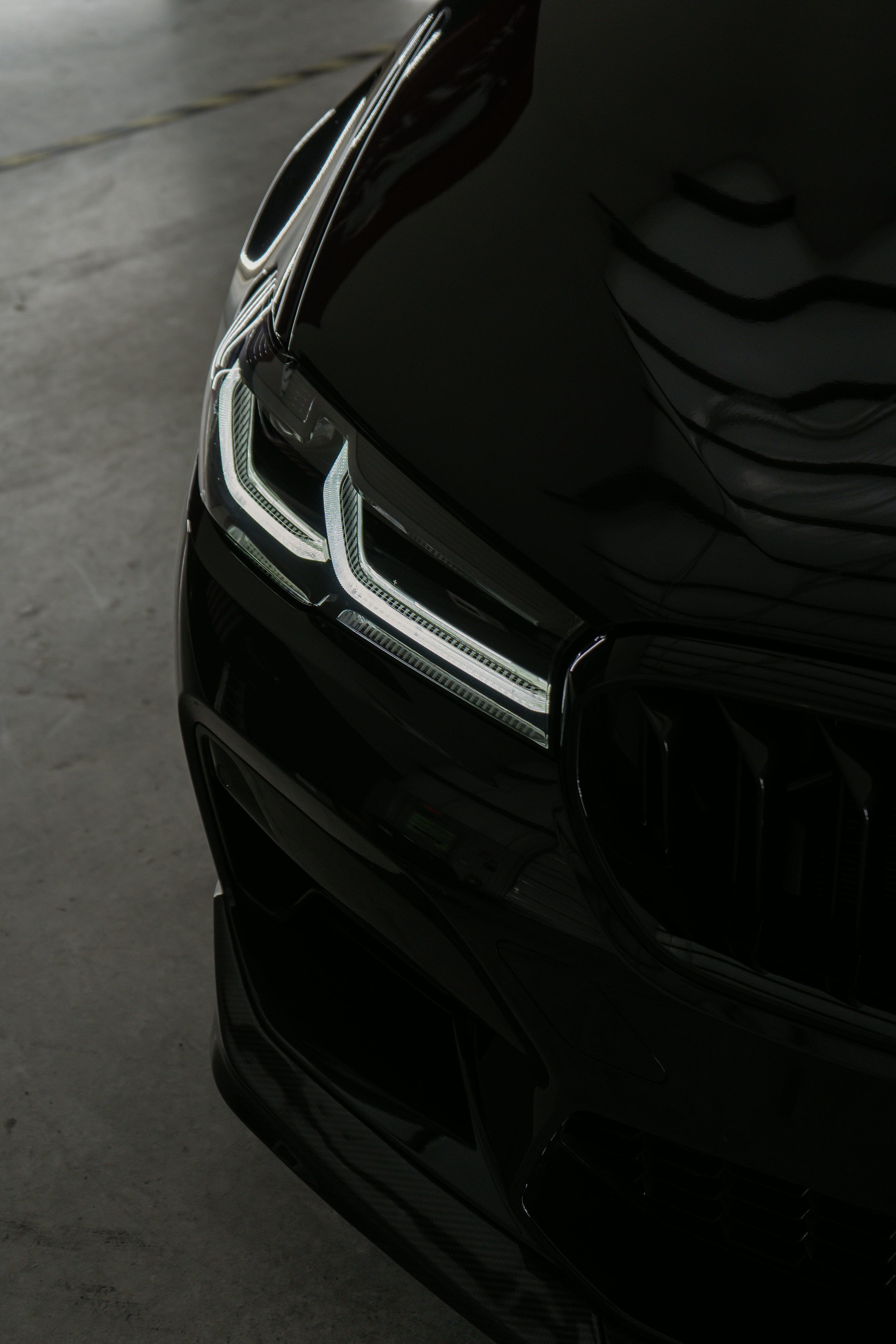 3000x4500 A close up of the front of a black car photo