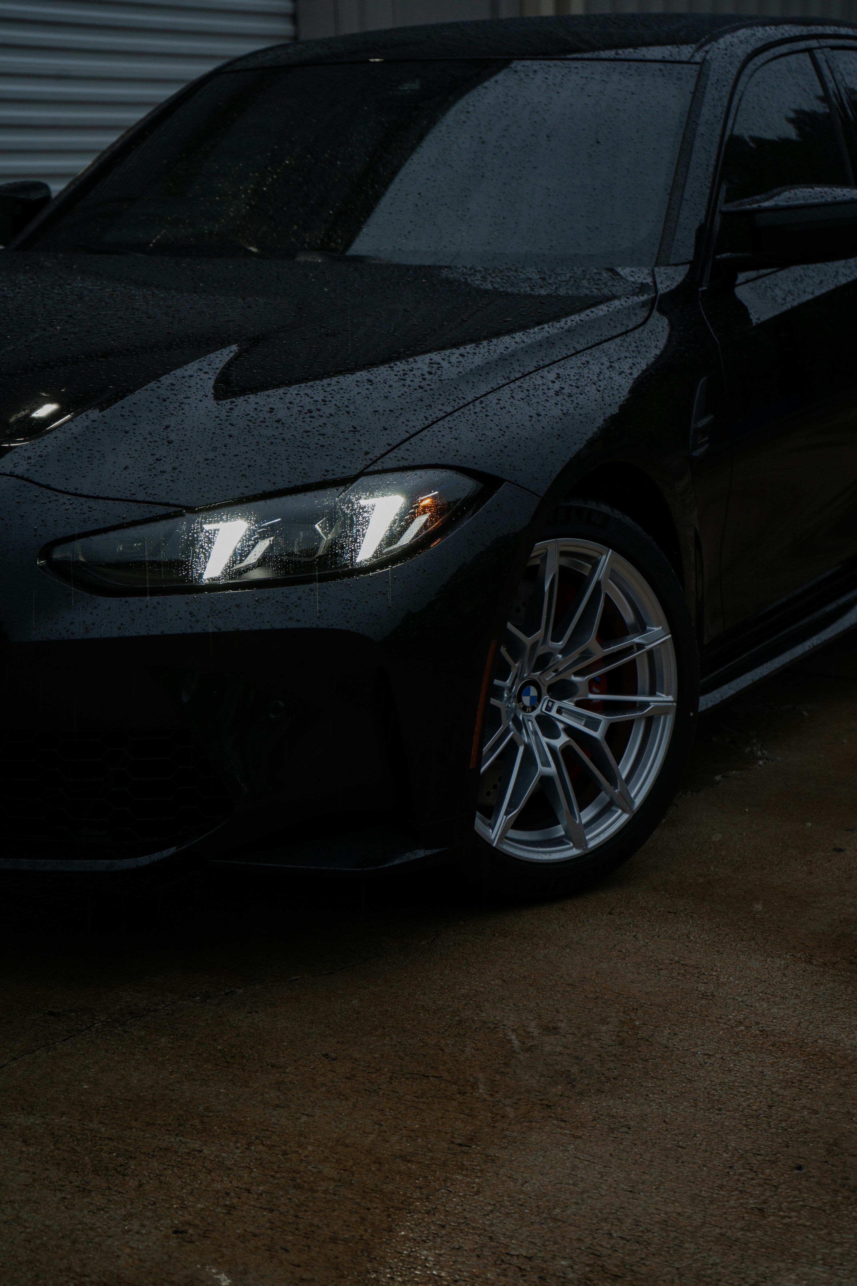3000x4500 A black BMW car is shown in the rain. photo