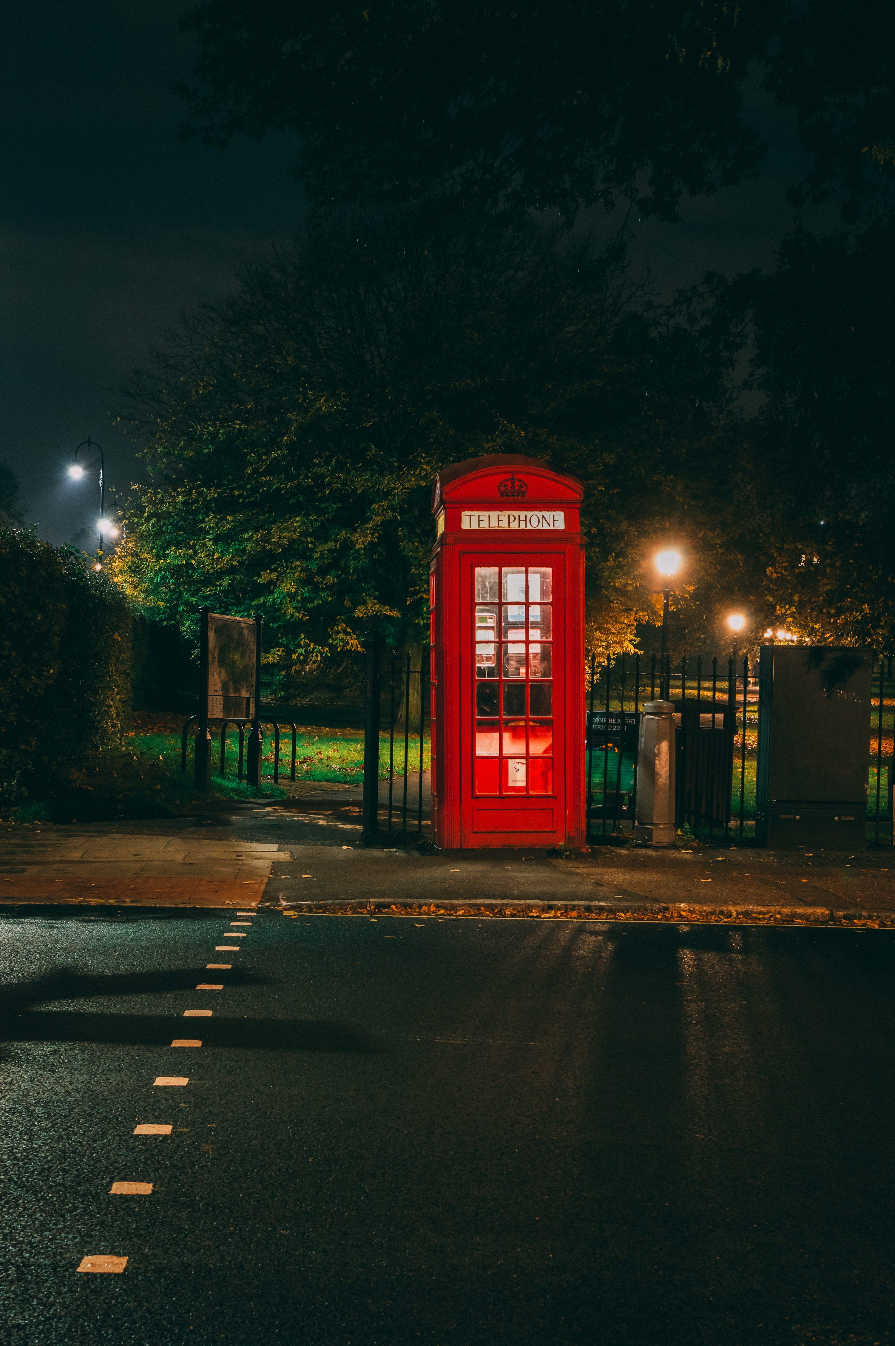 3000x4512 Empty red telephone booth at night photo