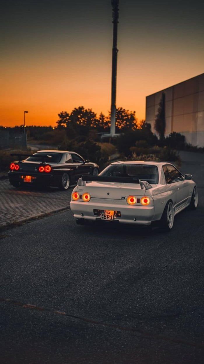 700x1245 Nissan Skyline and Nissan 350z in a Sunset Parking Lot. Old school jdm cars wallpaper, Nissan gtr r32 wallpaper, Nissan skyline r32 wallpaper iphone