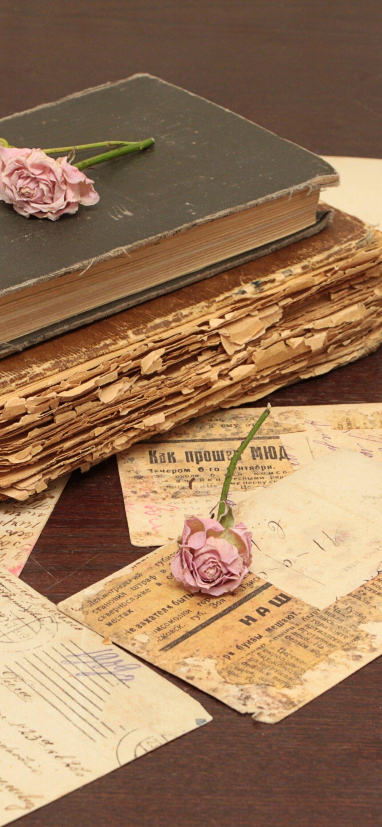 1242x2688 A old book, two candles and pink roses