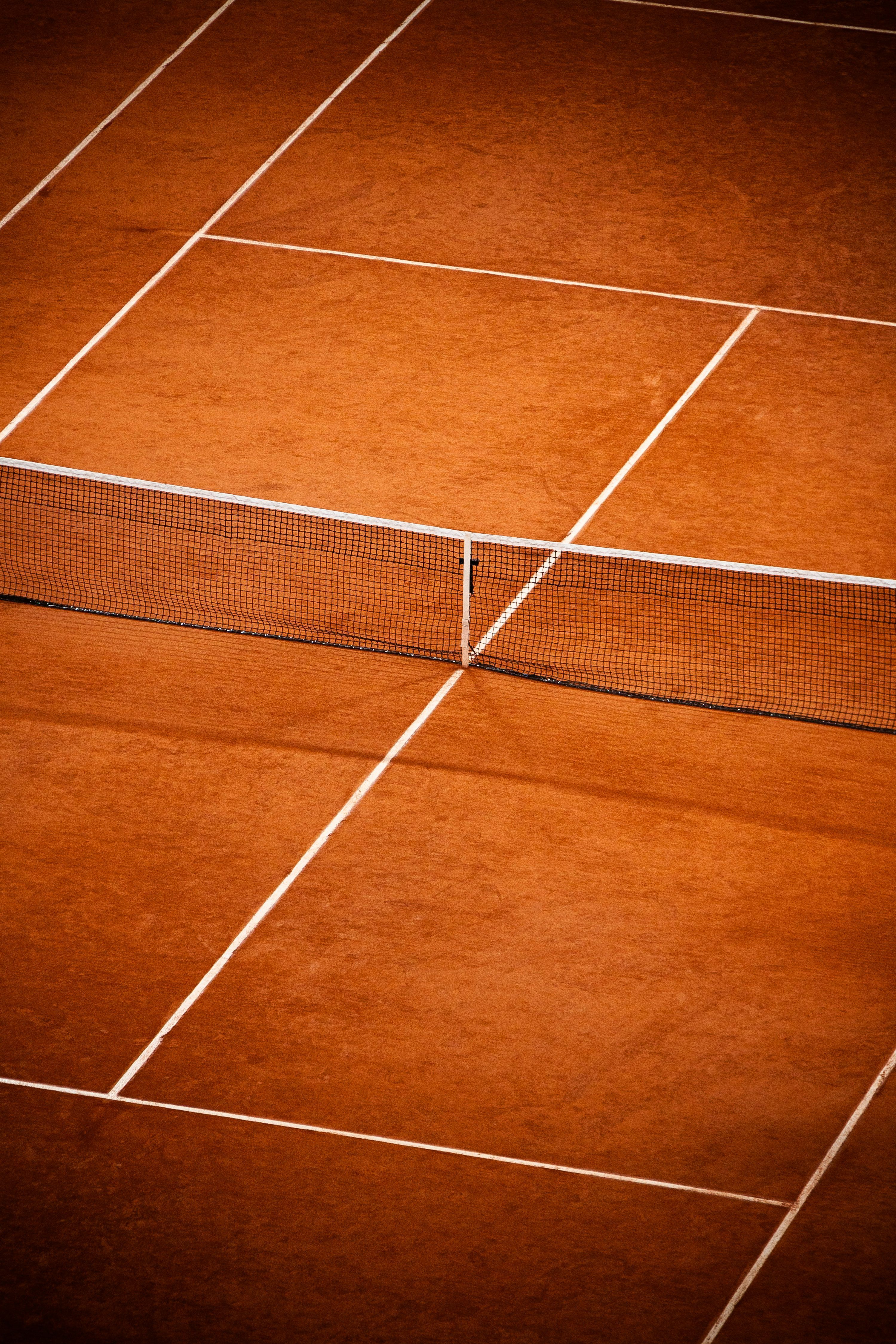 3000x4500 Clay tennis court with net and lines. photo