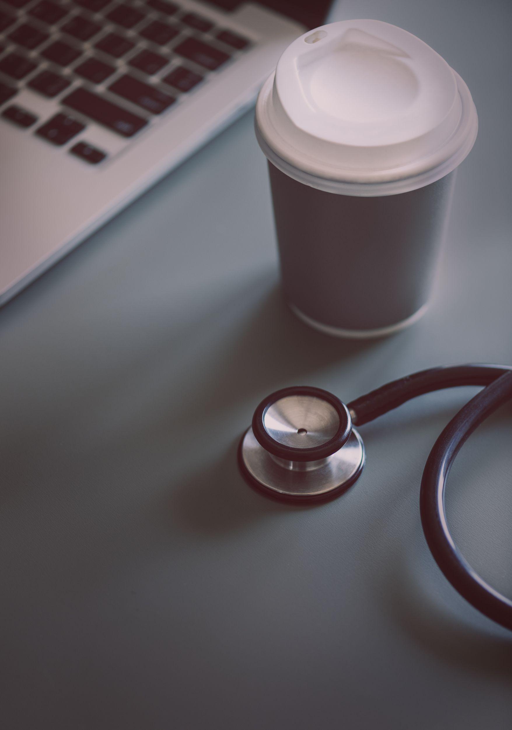 1755x2500 Gray and Black Stethoscope Beside Disposable Cup and Macbook Pro wallpaper