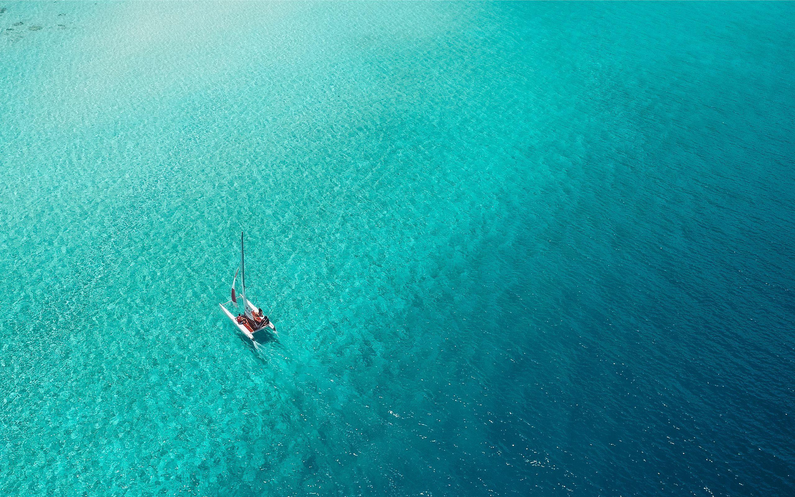 2560x1600 A catamaran sails across. Mac Wallpaper Download