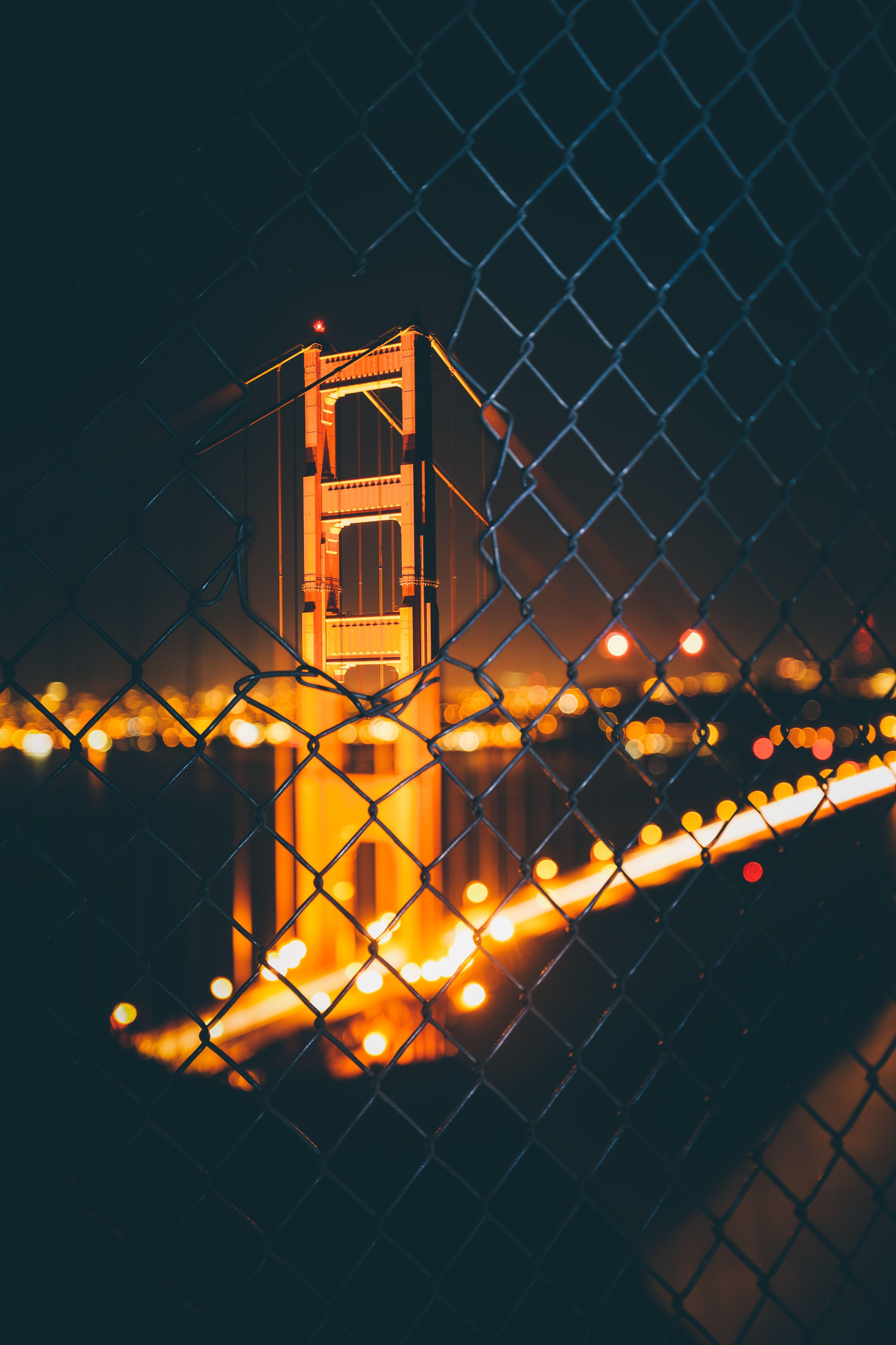 3840x5760 Download wallpaper 3840x5760 bridge, night, fence, mesh, blur, bokeh, glare HD background