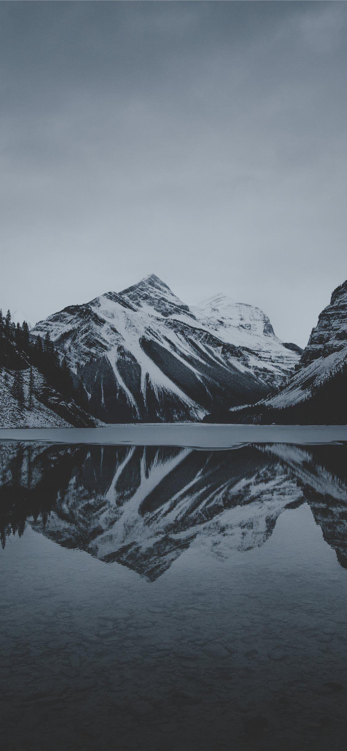 1125x2436 snow mountains and lake undr gray sky iPhone 11 Wallpaper Free Download