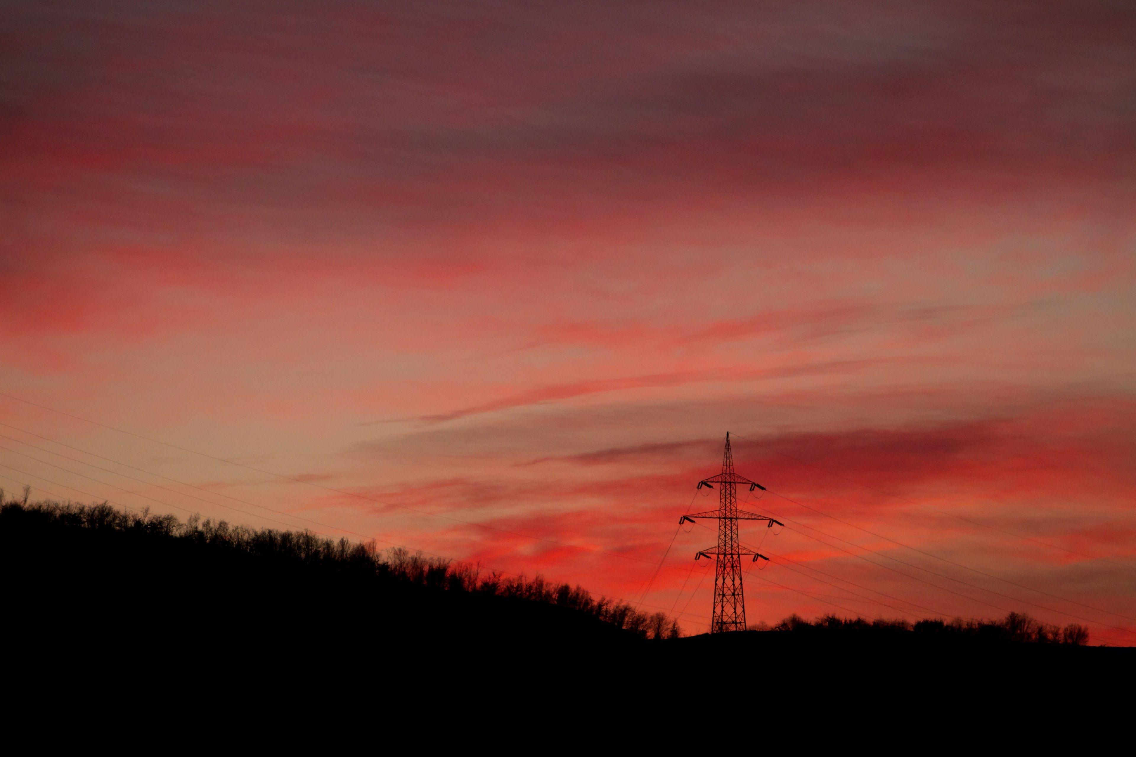 3840x2560 Wallpaper / a transmission tower among trees under a red sky at dusk, transmission tower at dusk 4k wallpaper