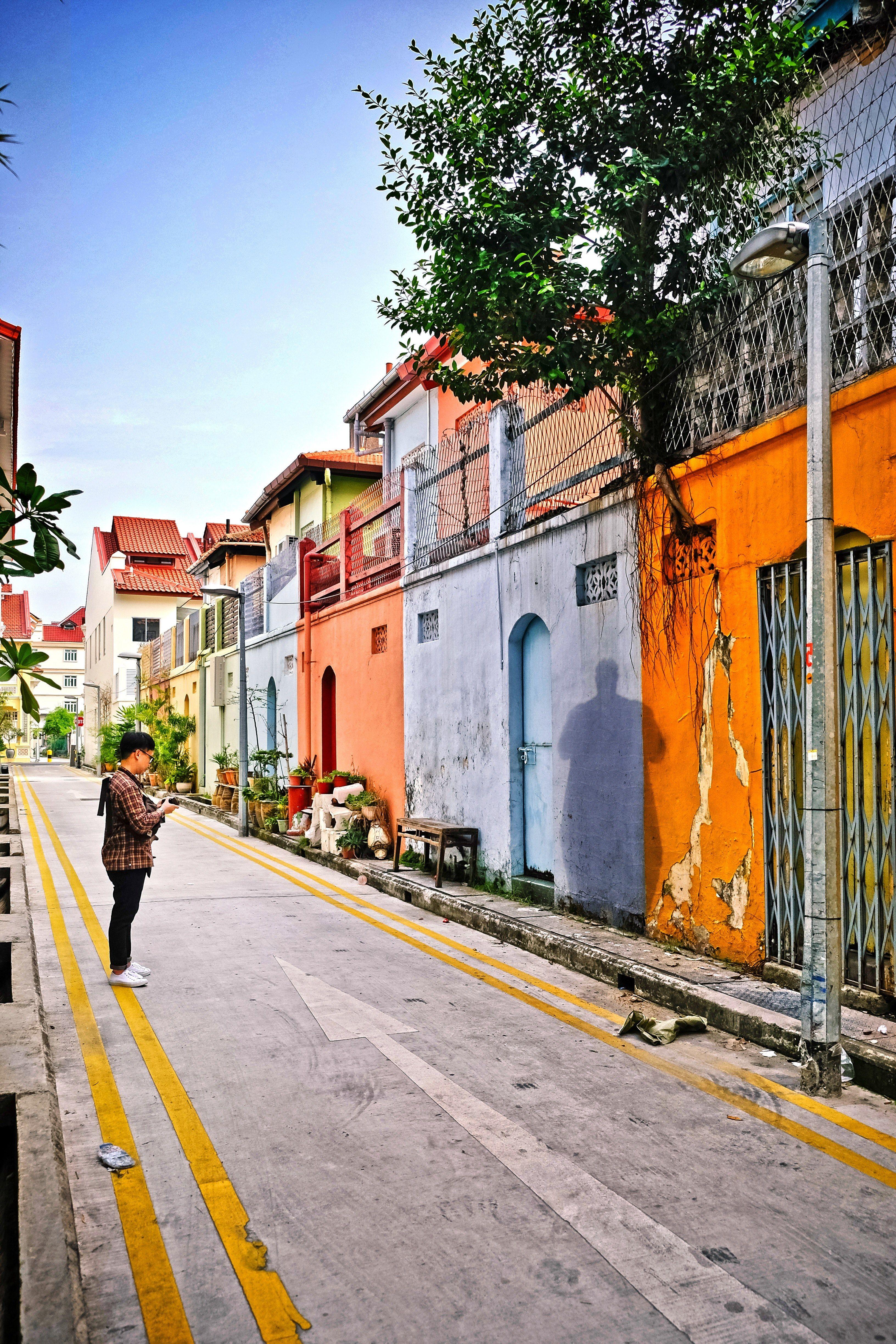 3264x4896 Wallpaper / street view of colorful asian houses and a man in the street taking picture, colorful houses 4k wallpaper