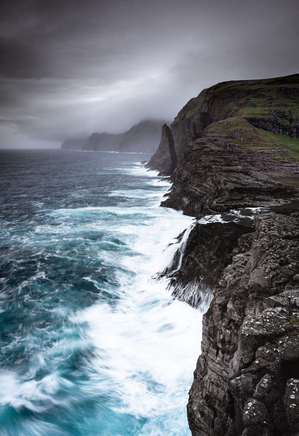 1000x1458 waves crashing sea cliffs digital wallpaper photo