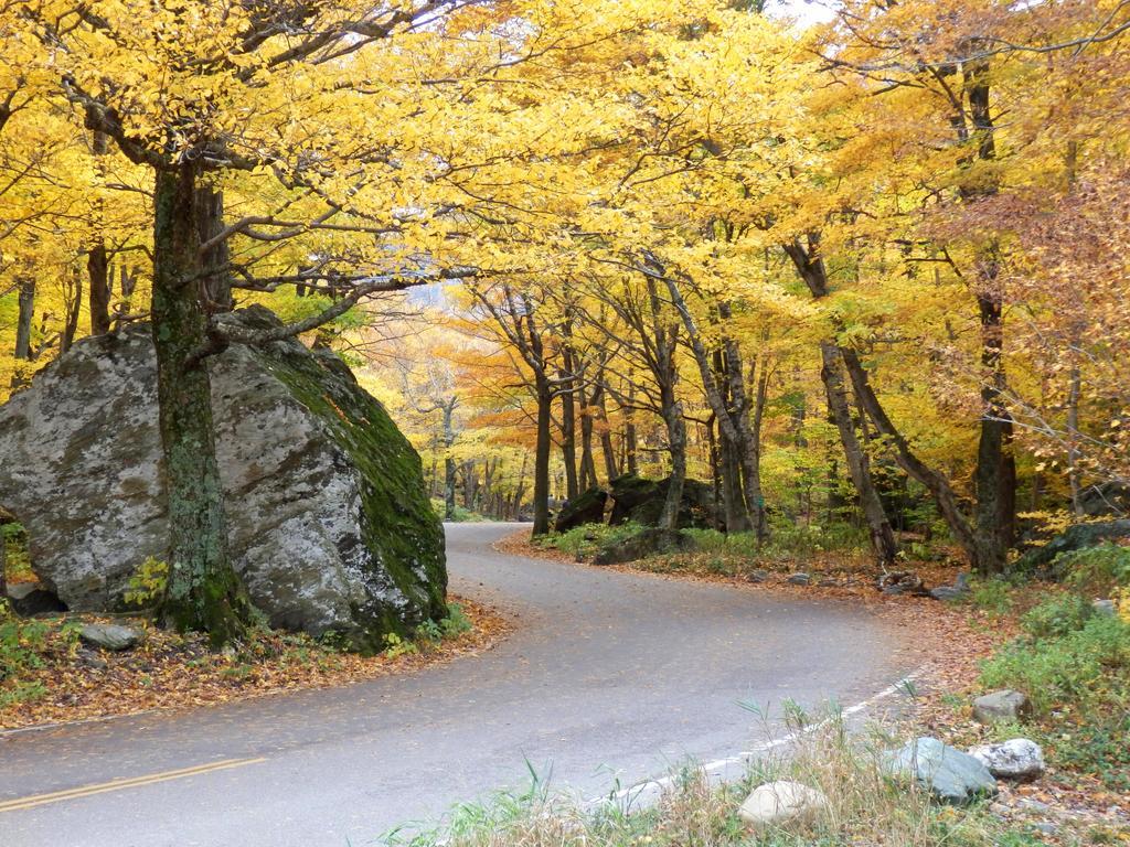 1024x768 fall foliage where Route 108 threads through Smugglers Notch in Vermont