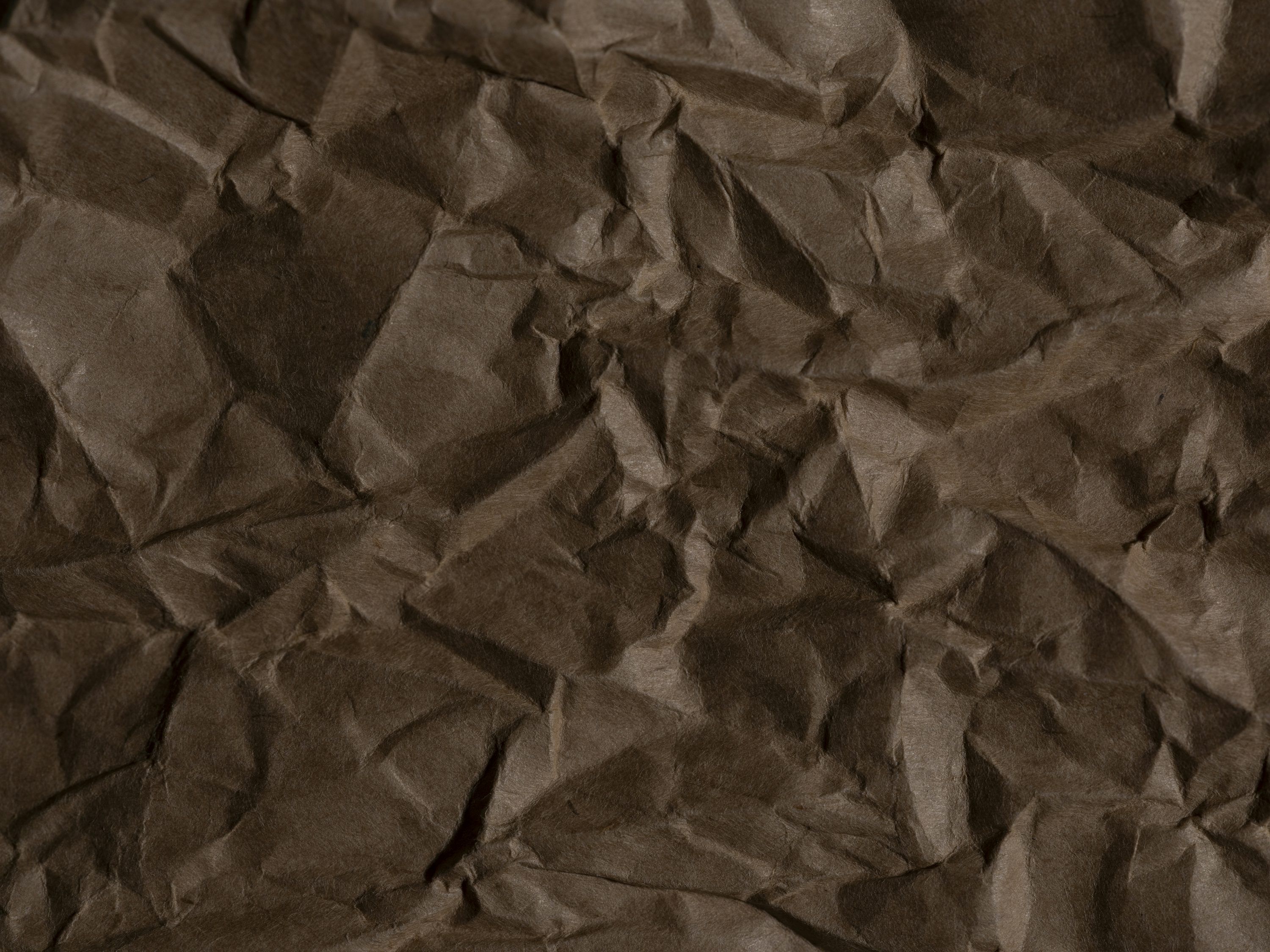 3000x2250 A piece of brown paper that is crumpled photo