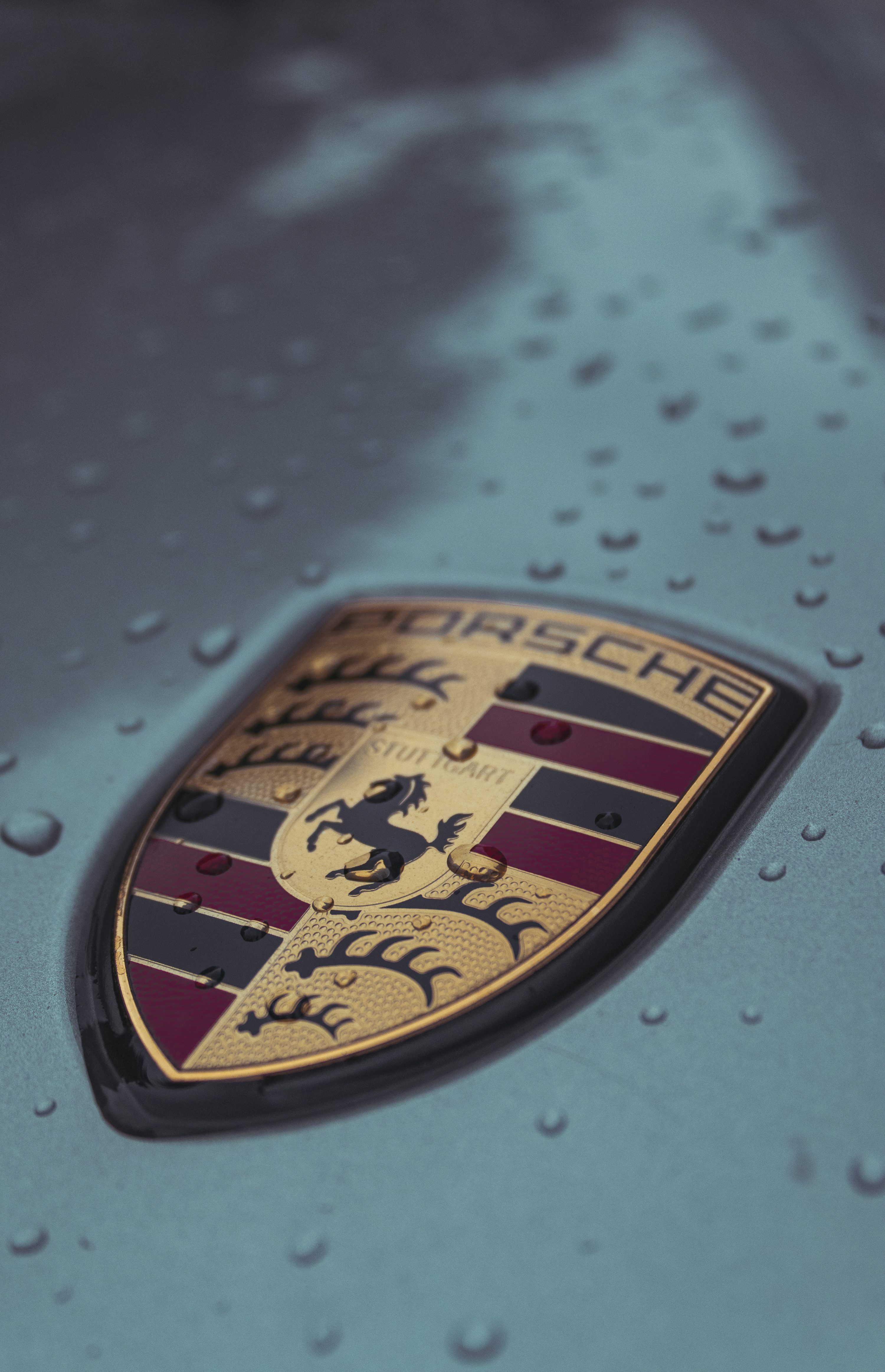3000x4652 A close up of a porsche emblem on a car photo