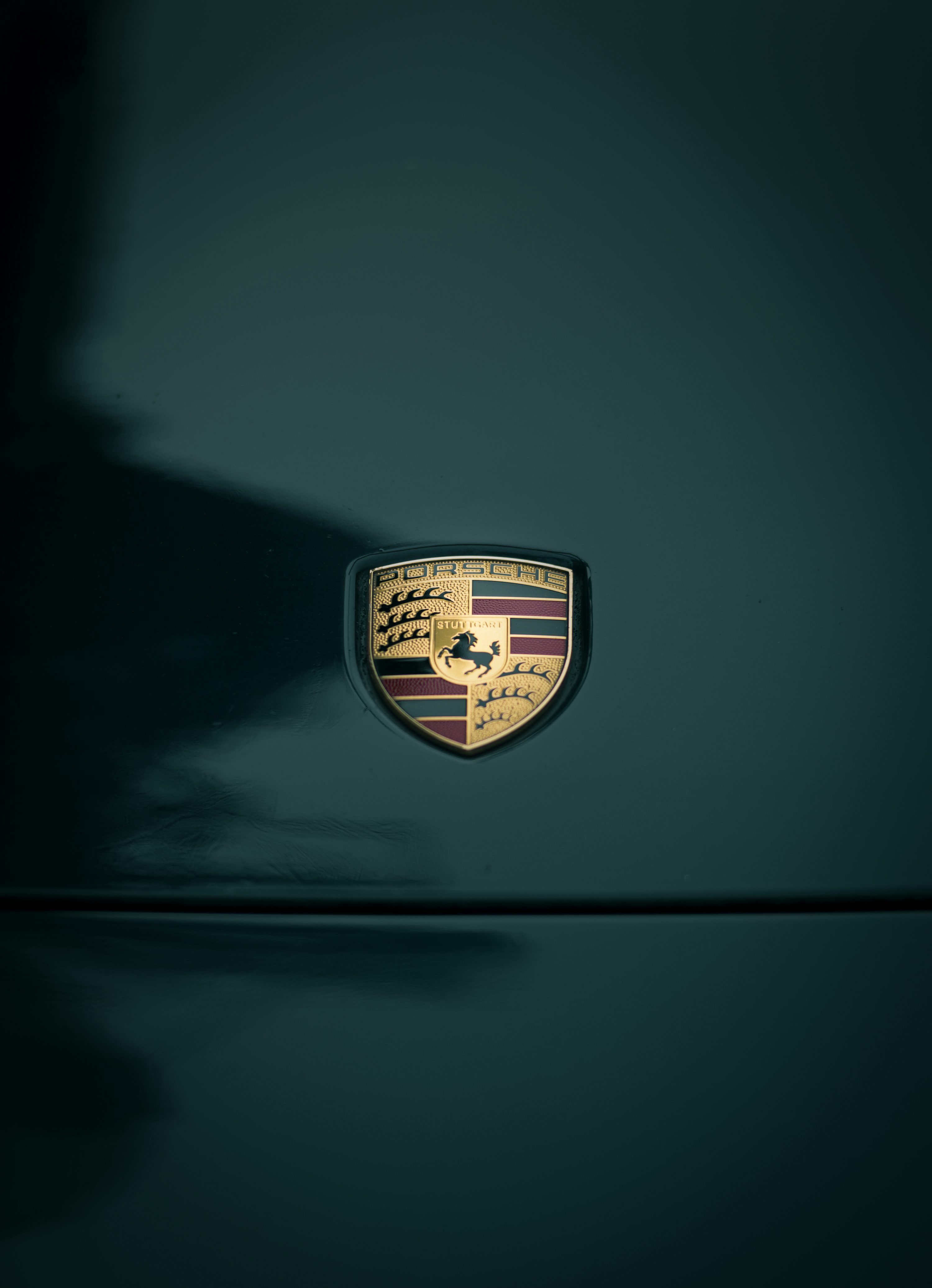 3000x4149 A close up of the emblem on a green car photo