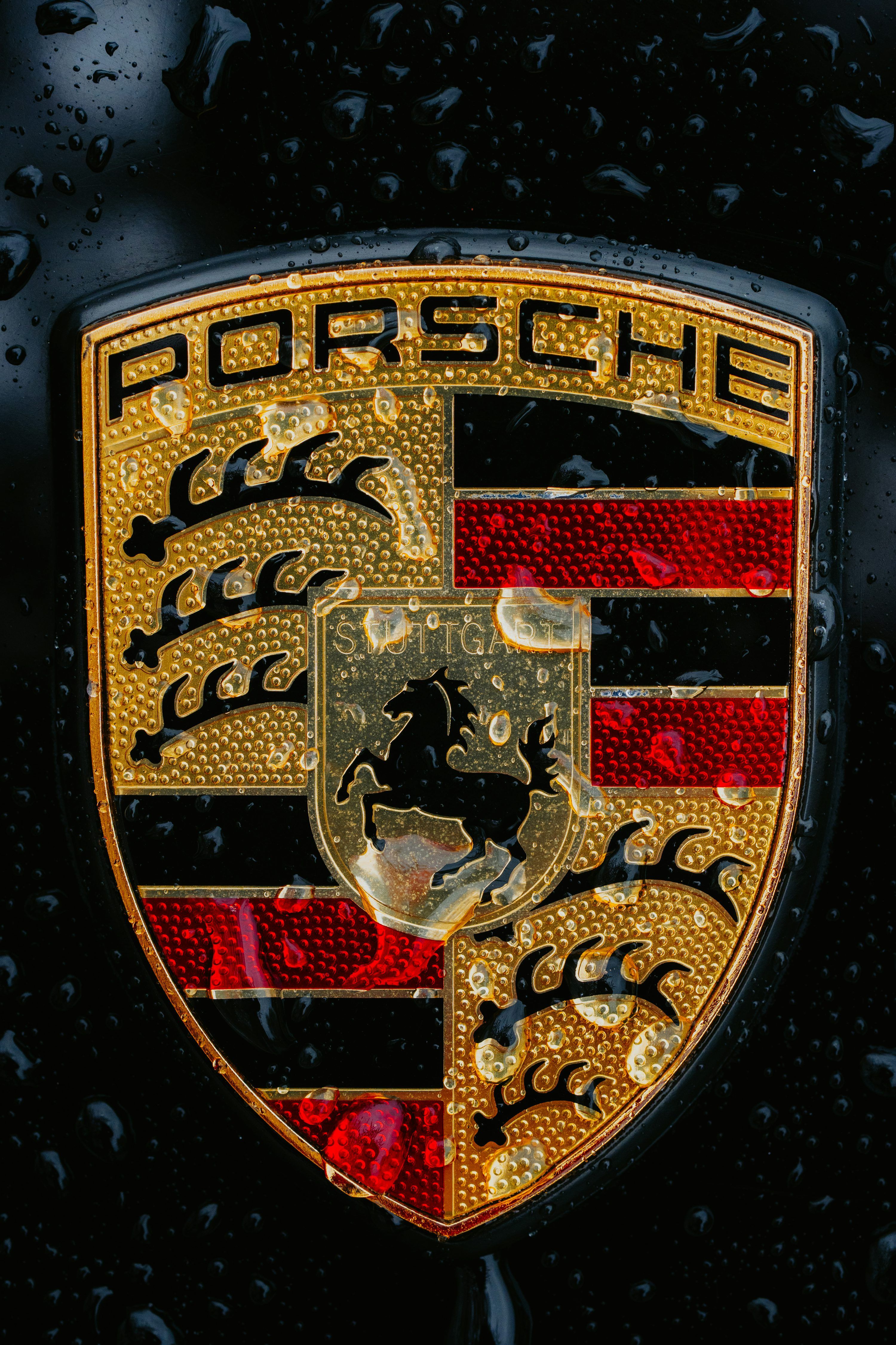 3000x4500 A Close Up Of A Wet Porsche Emblem. Photo