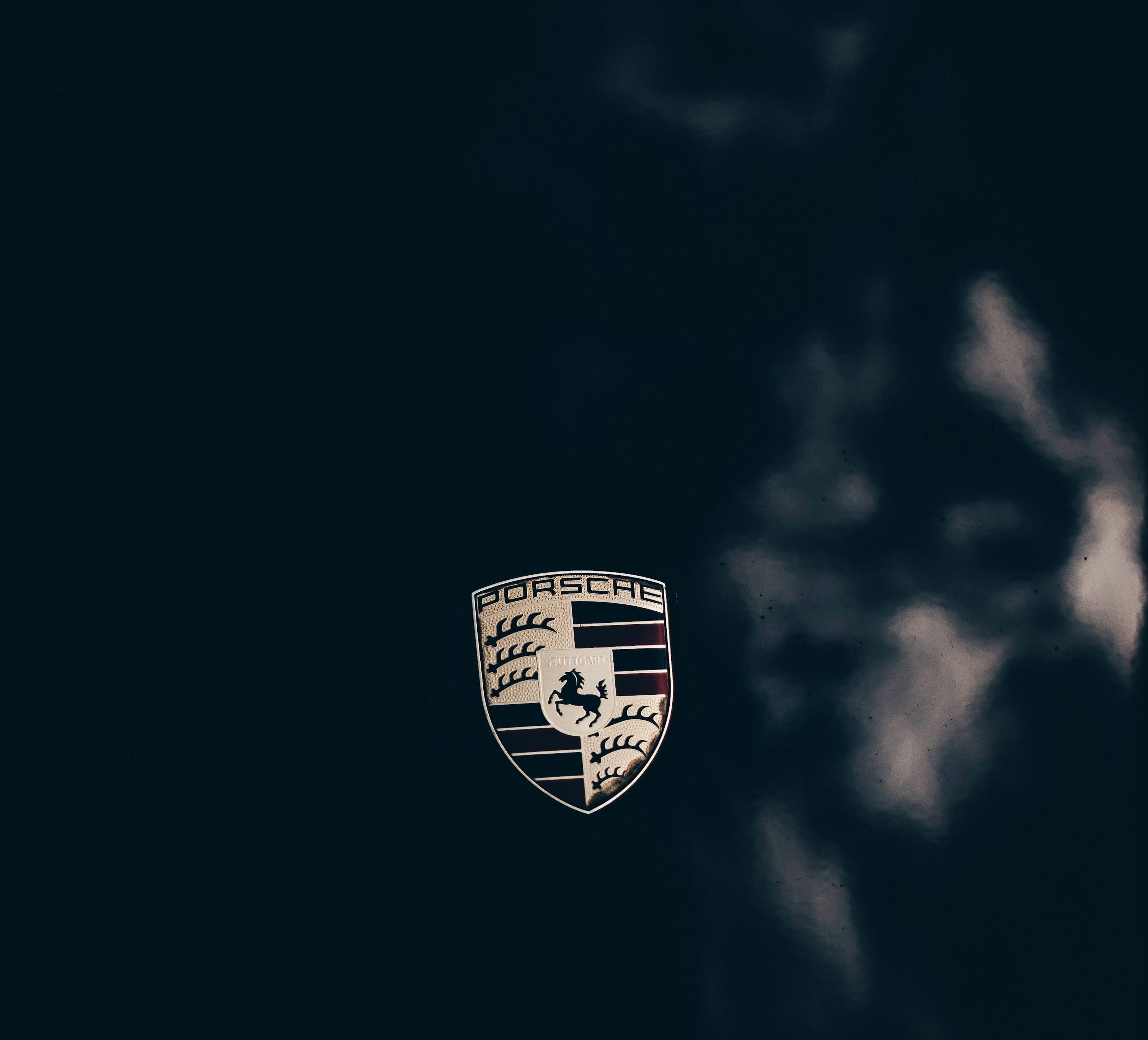 3000x2717 A porsche emblem on a black background photo