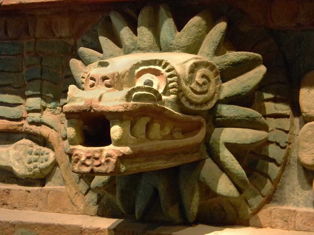 1024x768 Quetzalcoatl god aztec. A stone sculpture of a sun face on