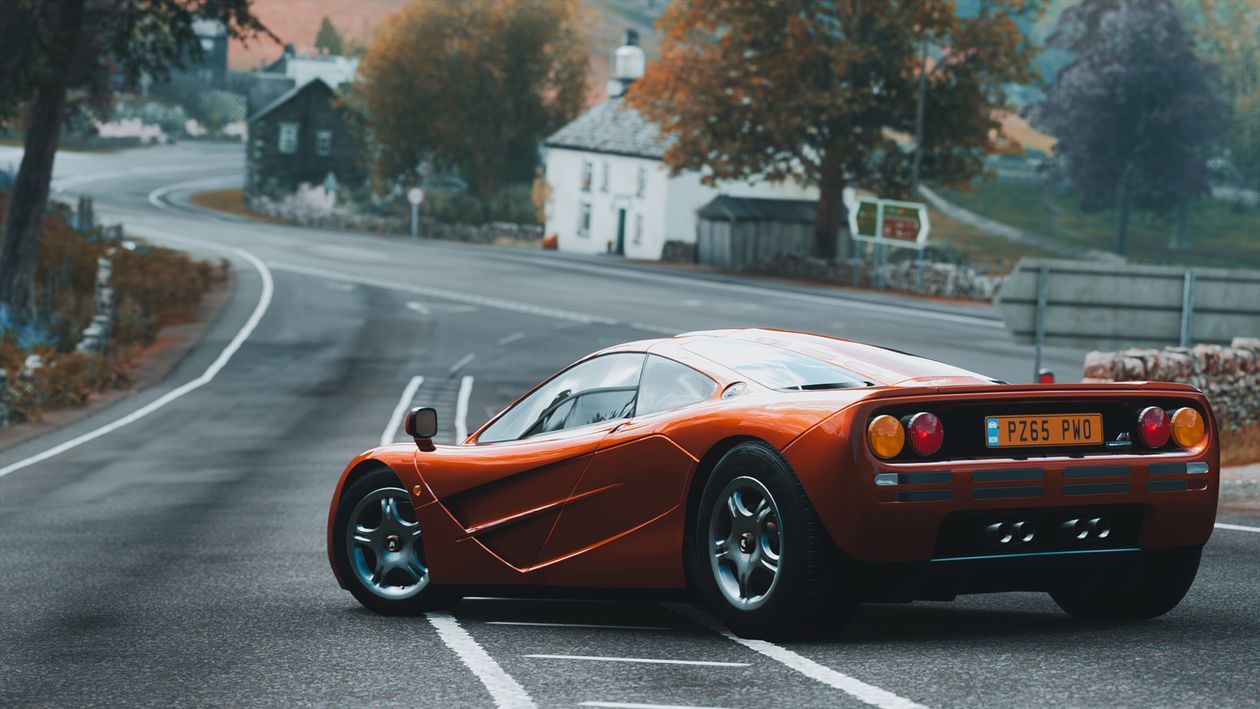 1260x709 Back View Shot of McLaren F1 LM Parked on the Road · Free