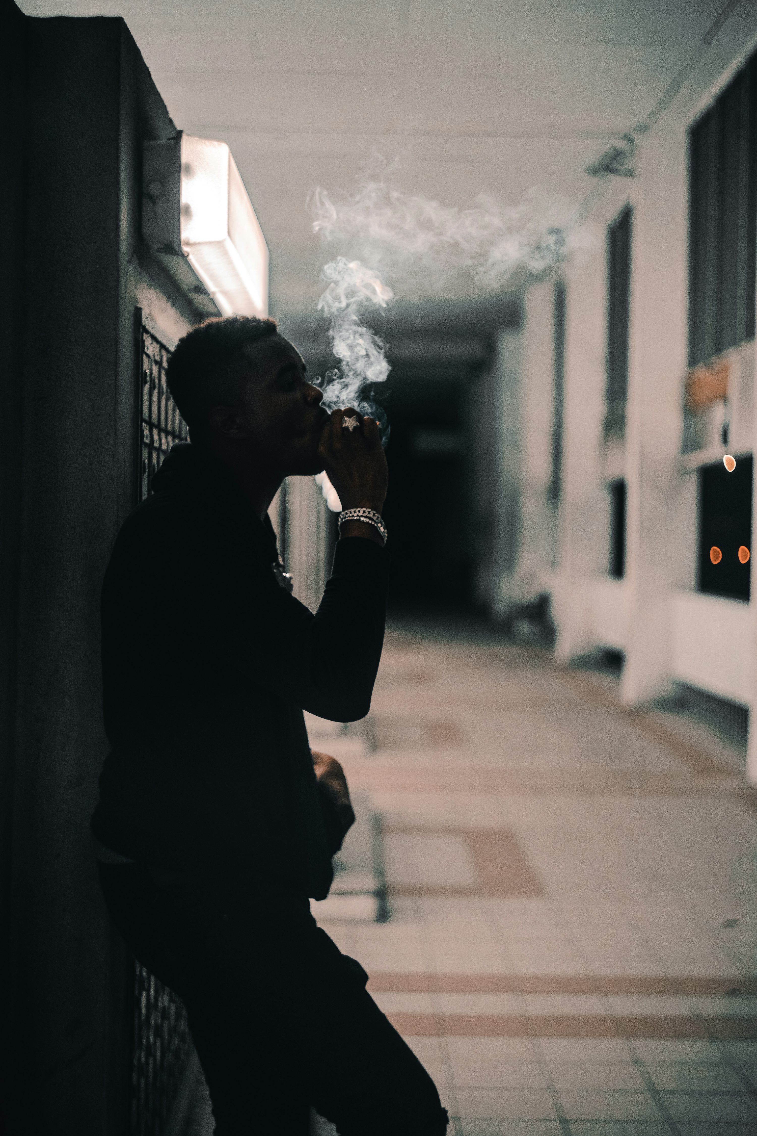 3000x4500 Photography of smoking man while leaning on wall photo