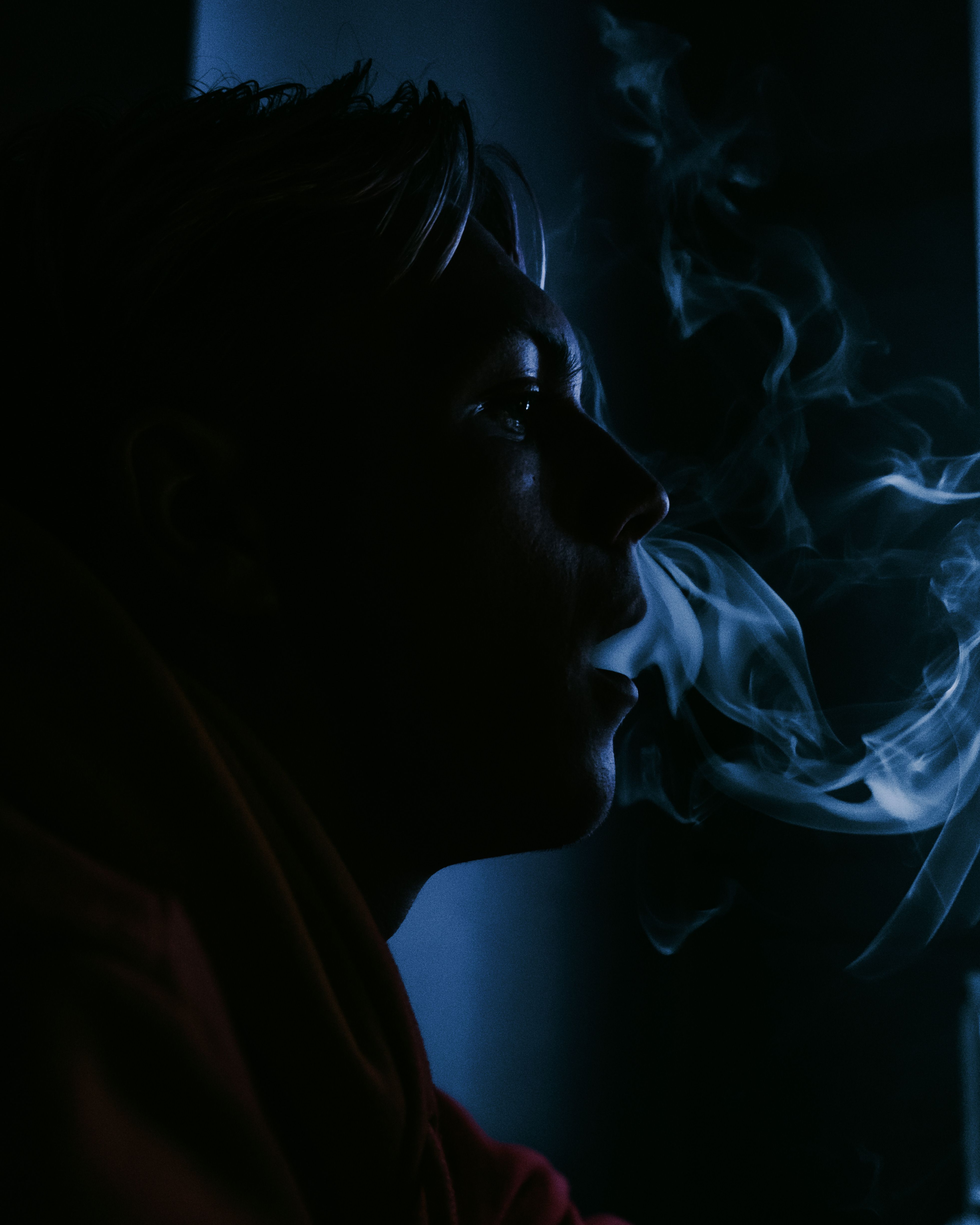 3922x4902 Silhouette of a Man Smoking on the Background of Neon Lights · Free