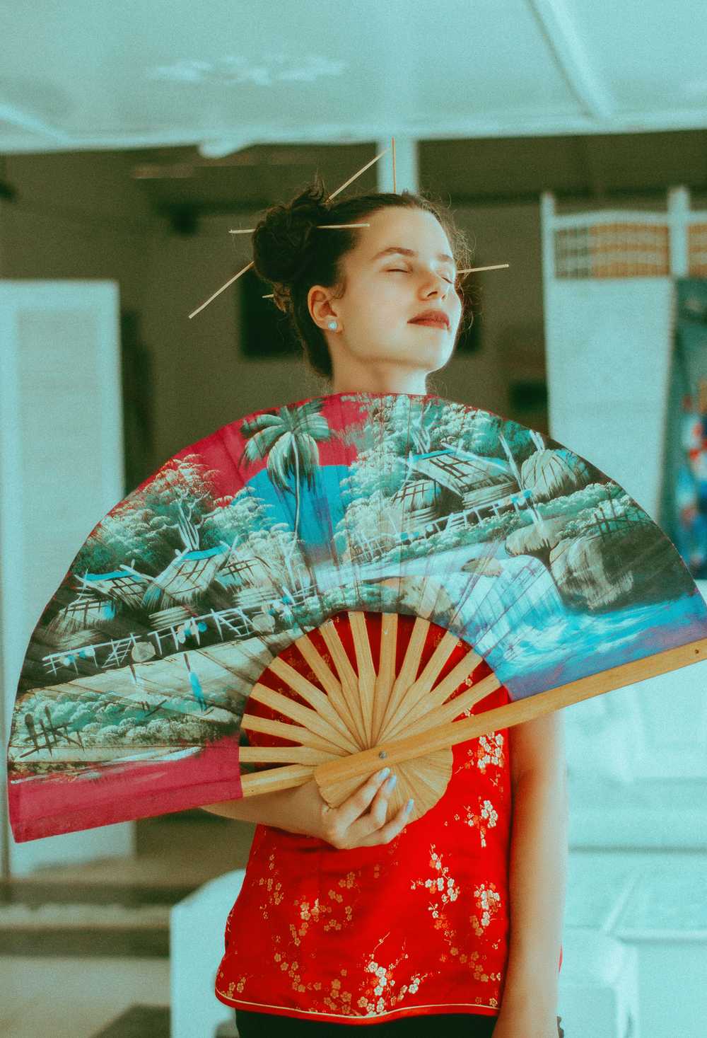 1000x1467 Woman Standing And Using Multicolored Big Handfan While Closing Her Eyes HD Wallpaper Hub