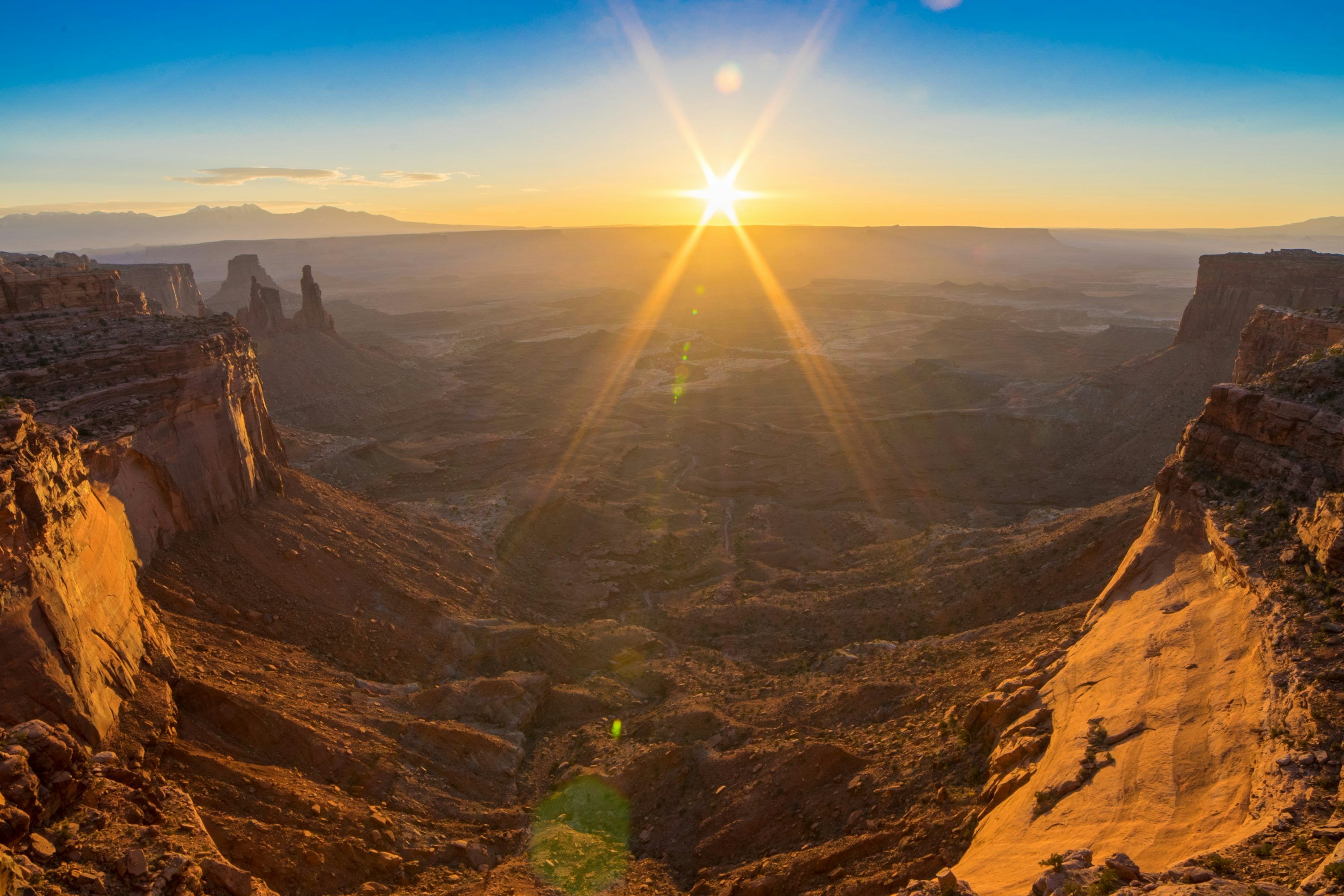 3000x2000 The sun is setting over a canyon in the desert photo