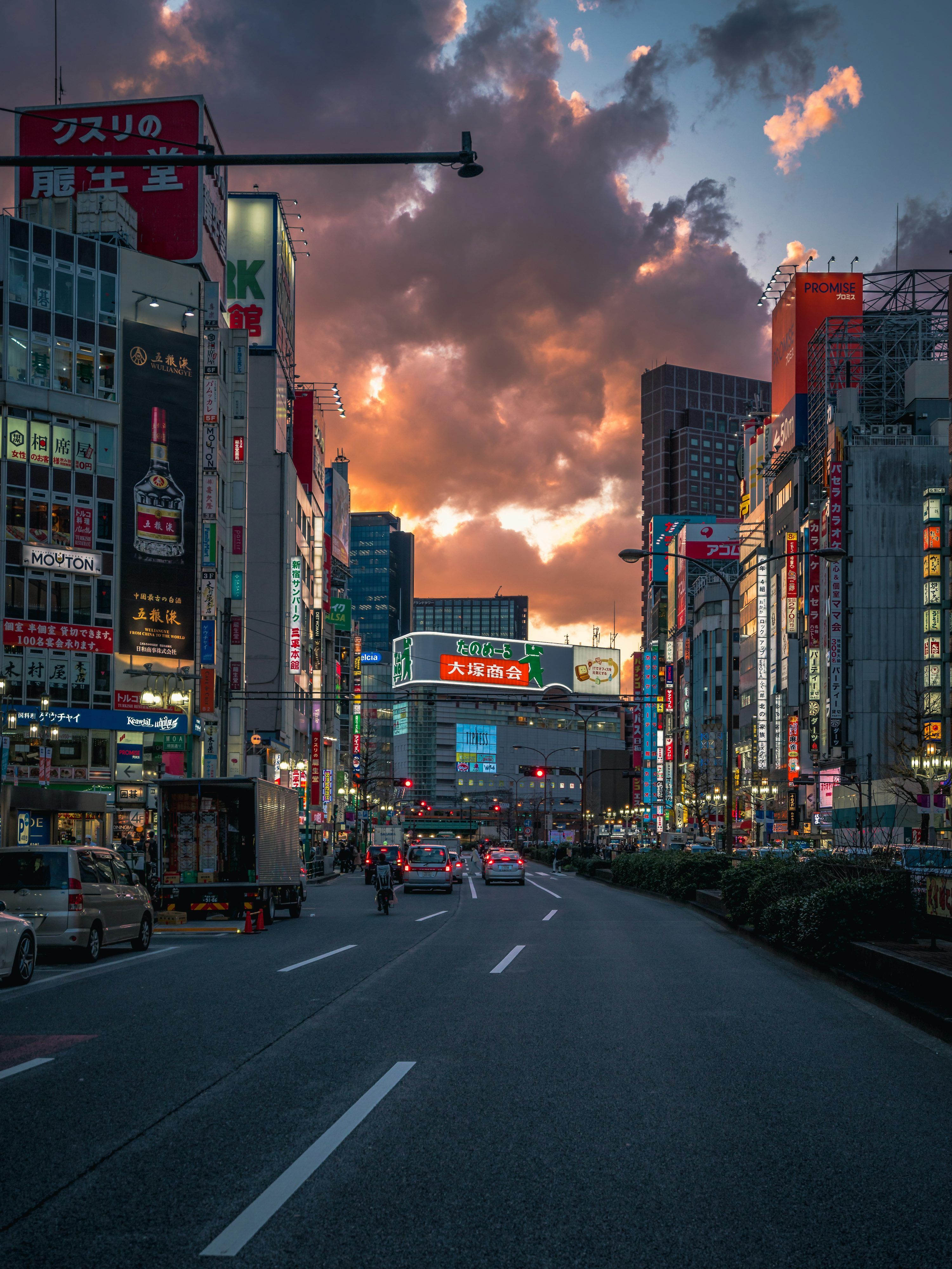 3000x4000 Cars on road between high rise buildings during daytime photo