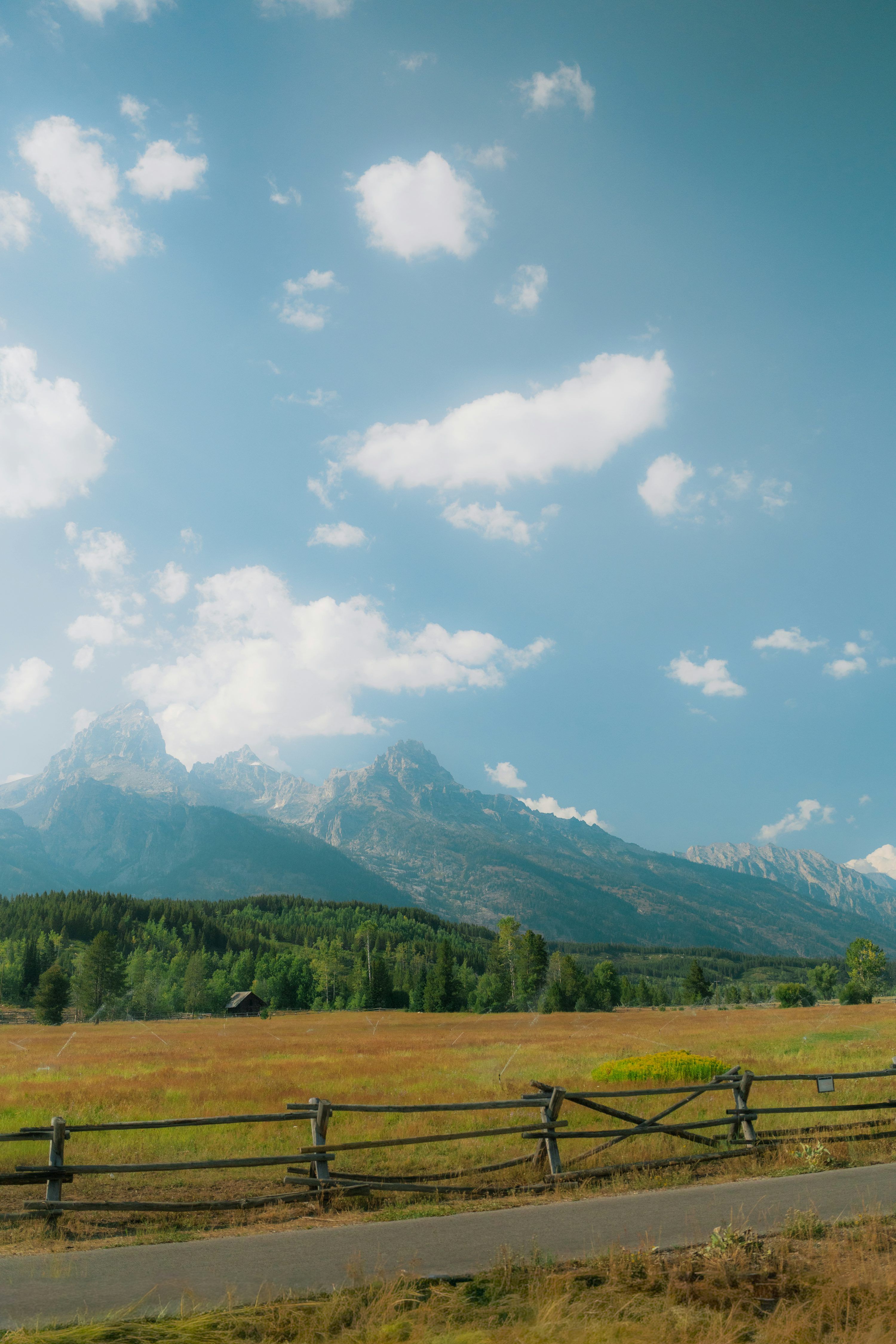 3000x4500 Wooden fence in front of mountains and field. photo