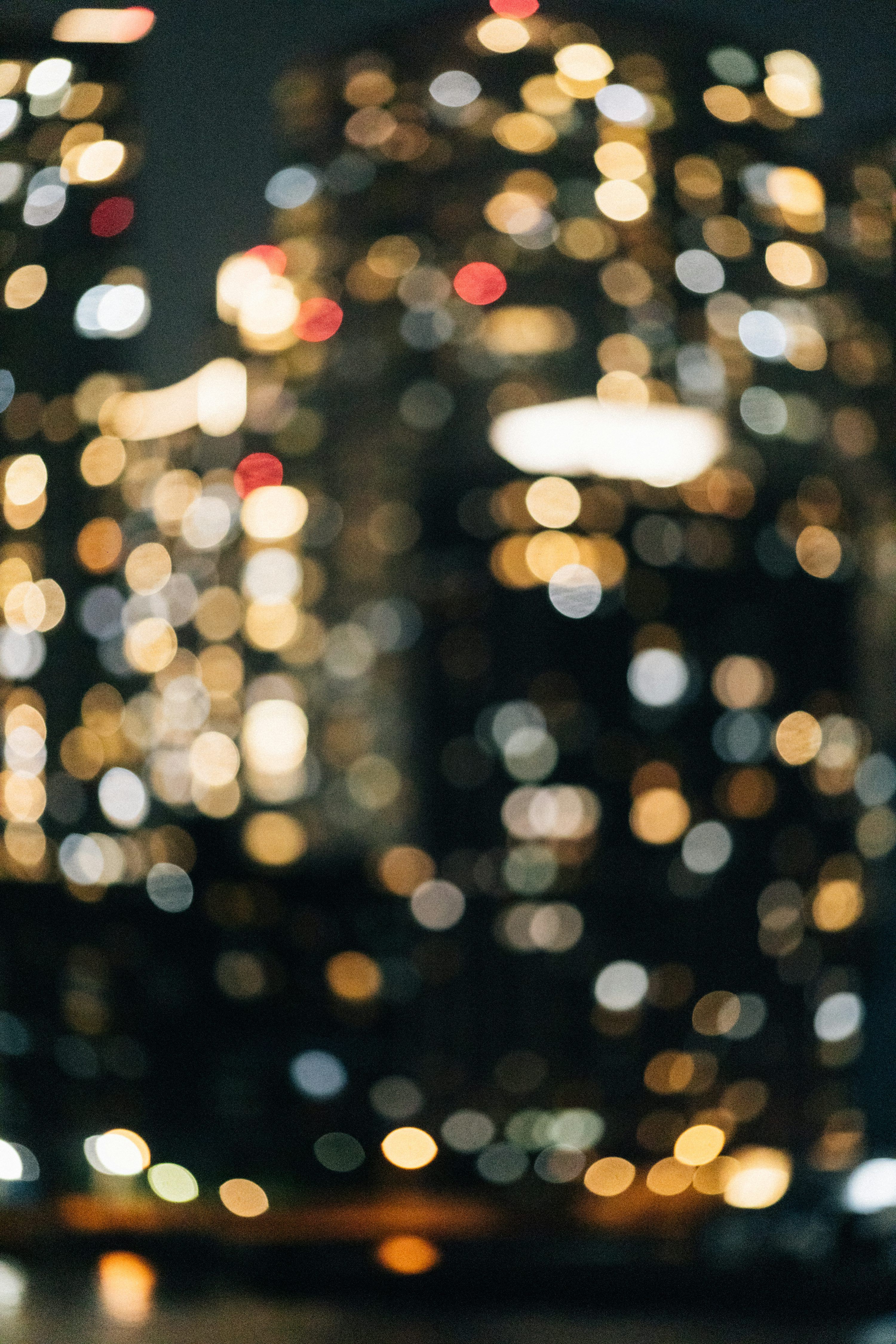 3000x4499 Blurred city lights at night create a bokeh effect. photo