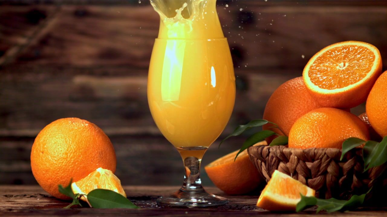 1280x720 Variety of fruit and juices on black background