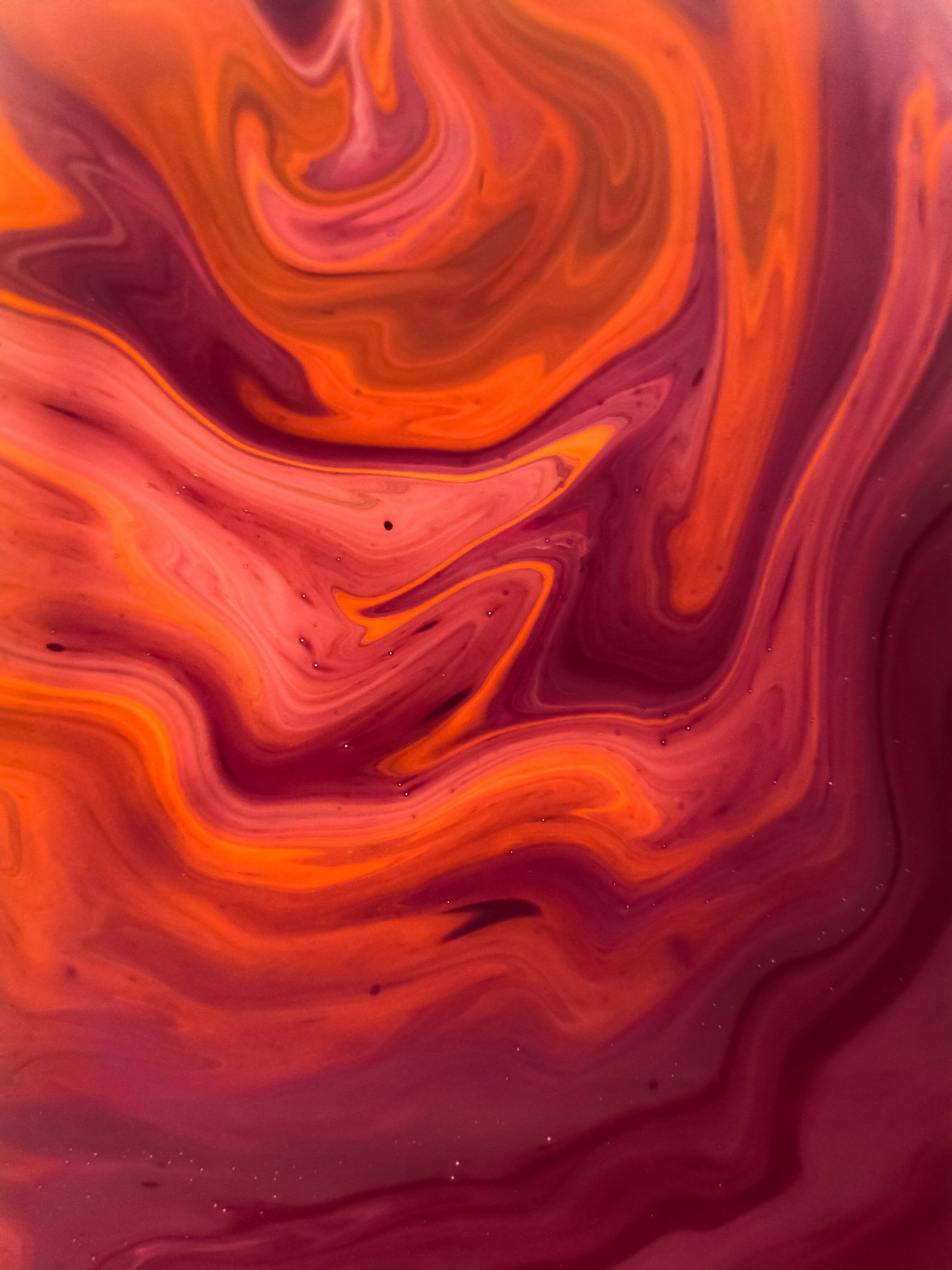 3000x4000 A red and orange swirl with a black background photo