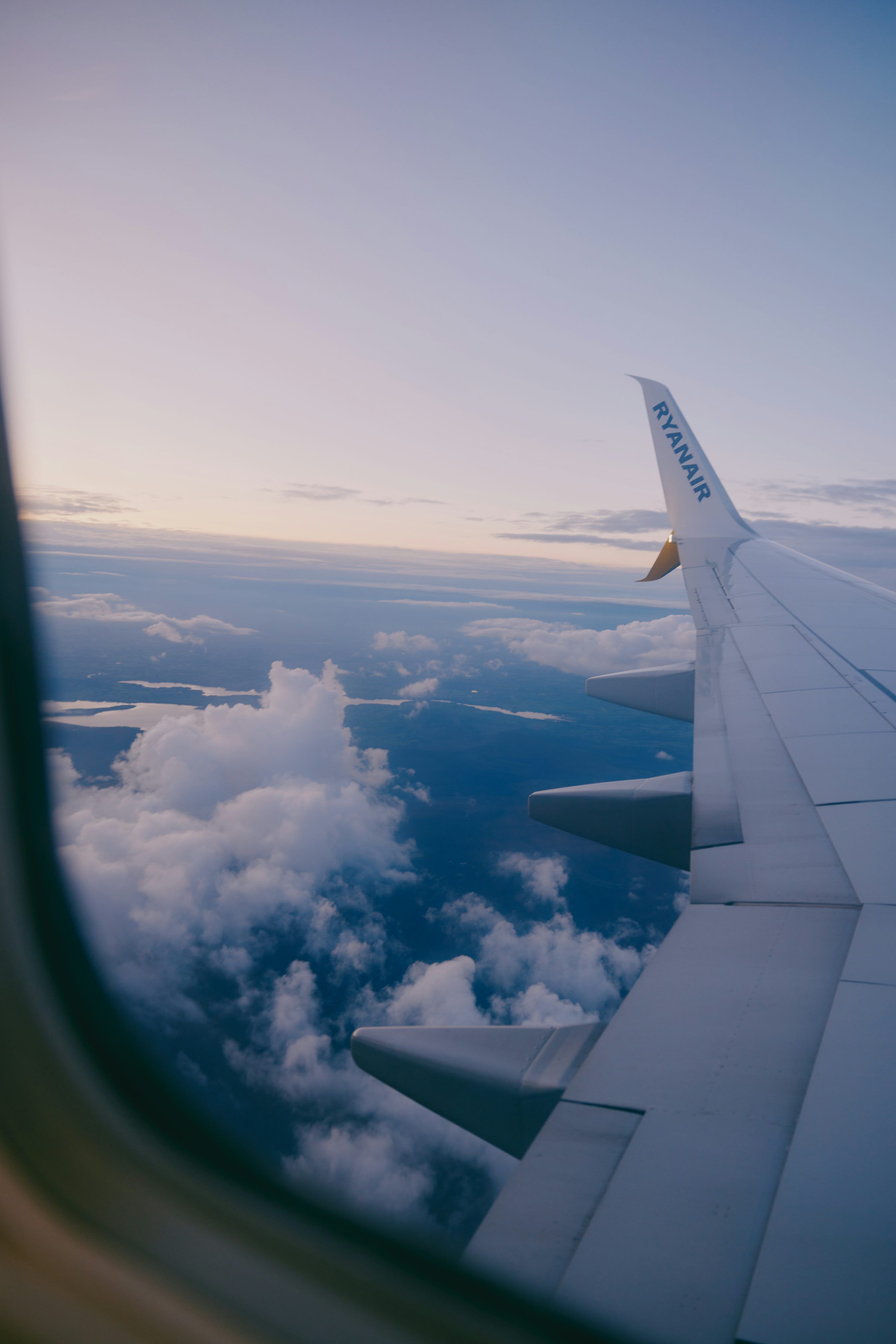 3000x4498 View from airplane window of wing and clouds. photo