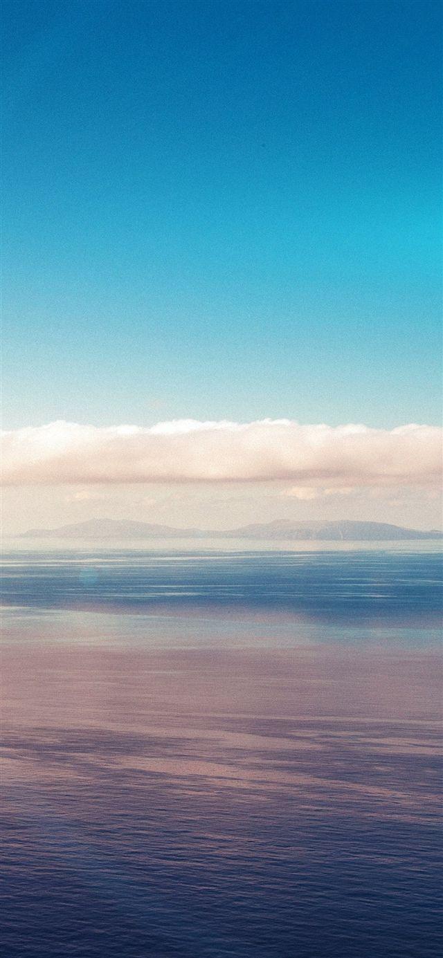 640x1385 Blue sky ocean view flare iPhone X Wallpaper Free Download