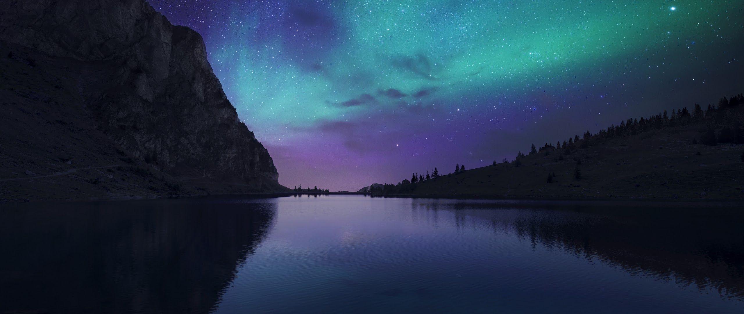 2560x1080 Aurora Borealis Night Sky Stars Lake Nature Scenery 4K Wallpaper