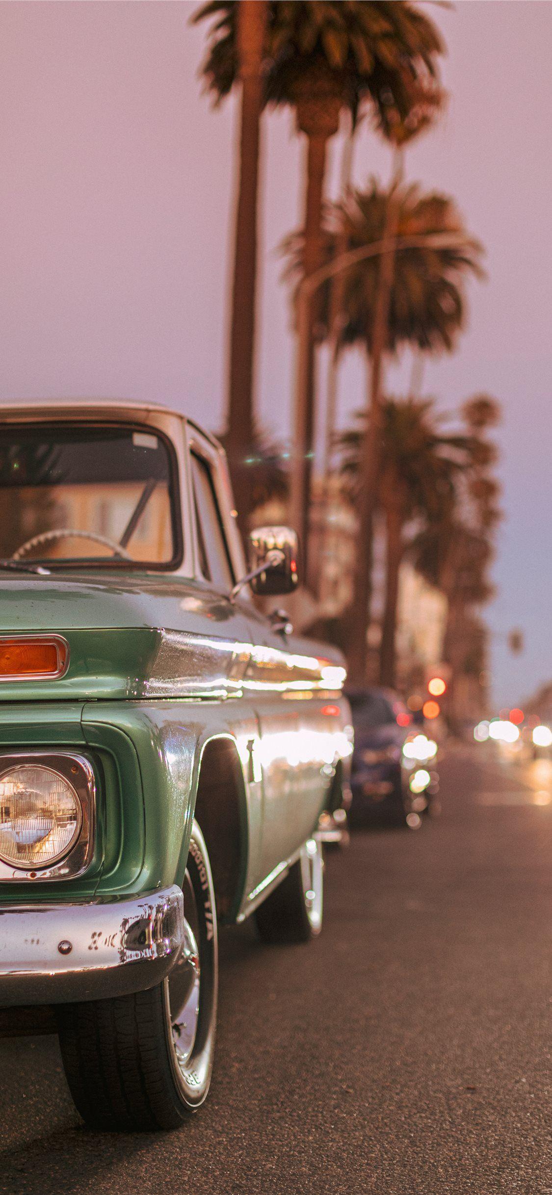 1125x2436 Vintage car parked on Ocean Blvd during sunset iPhone X Wallpaper Free Download