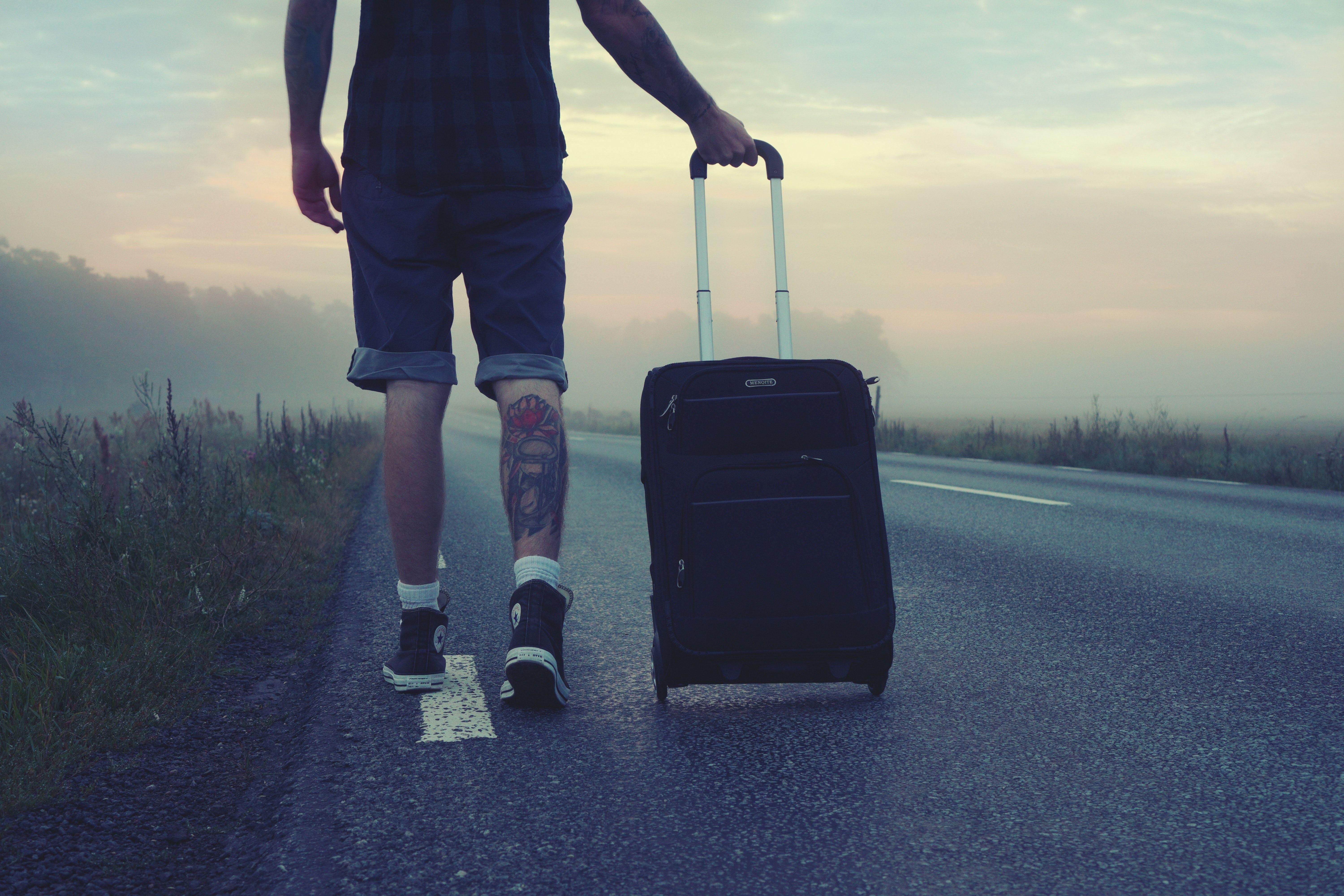 6000x4000 Man Walking on the Road Holding Black Luggage during Sunset · Free