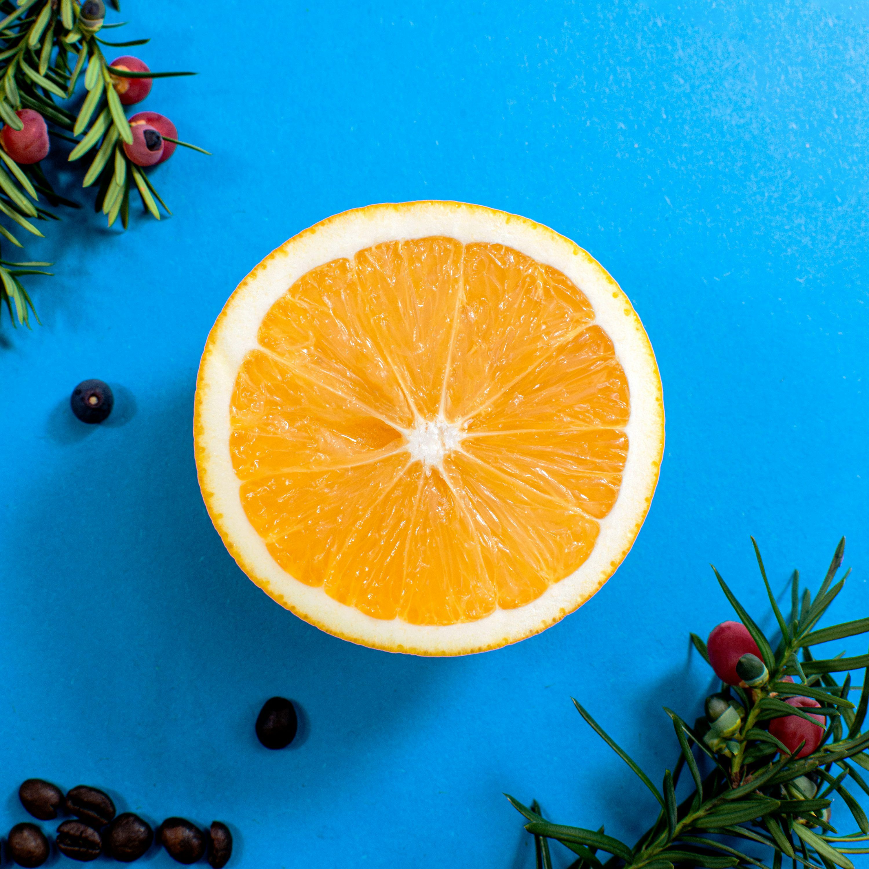 3000x3000 A slice of orange is on a blue surface. photo