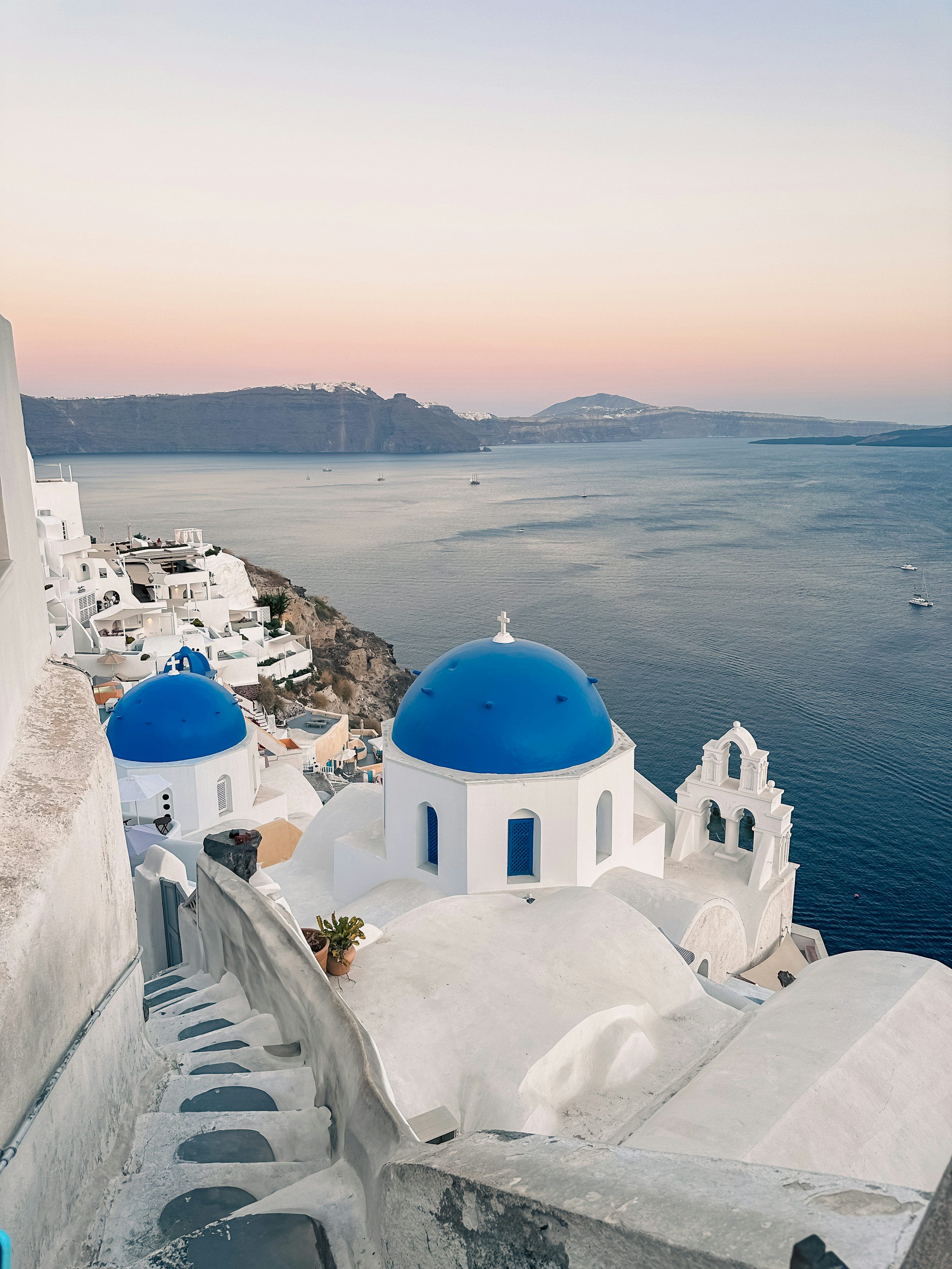 3000x4000 A blue and white church on the edge of a cliff photo