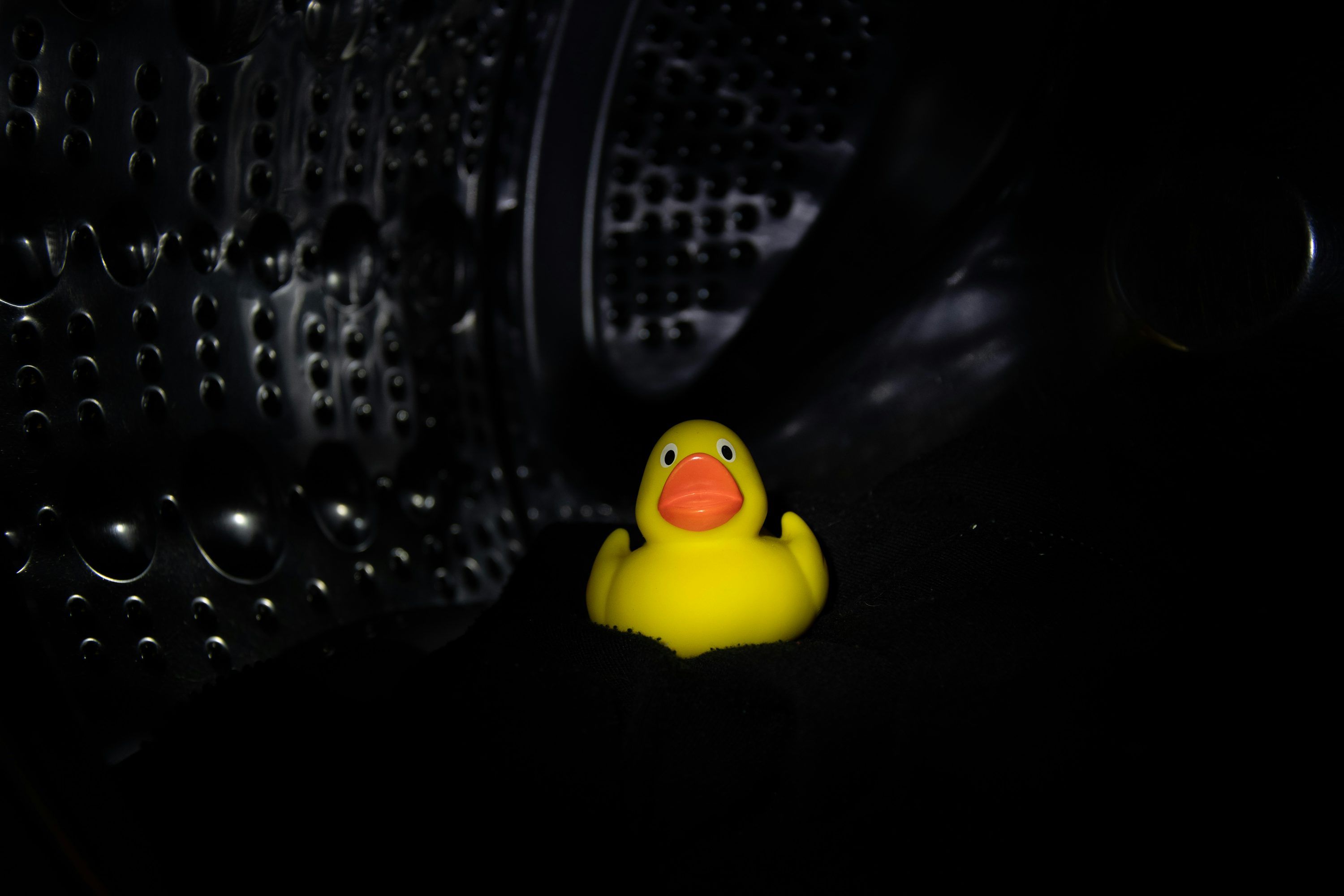 3000x2000 A yellow rubber ducky sitting in the dark photo