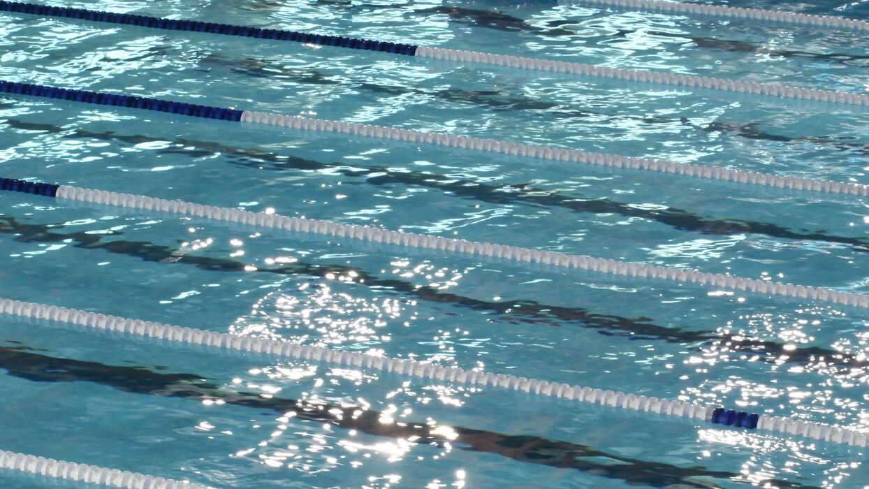 1244x700 Malaga, Spain, 2019 women swimming in a race competing in crawl style
