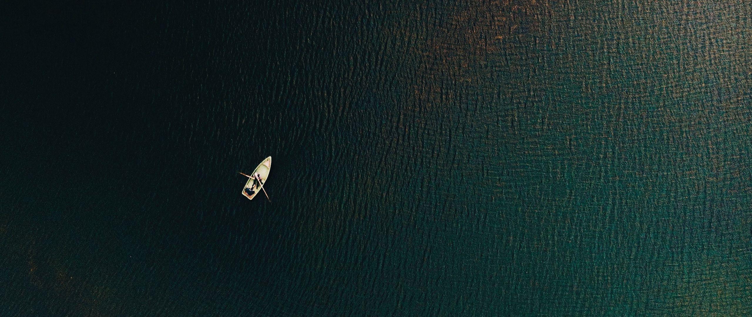 2560x1080 Download wallpaper 2560x1080 sea, boat, top view, ripples, water dual wide 1080p HD background